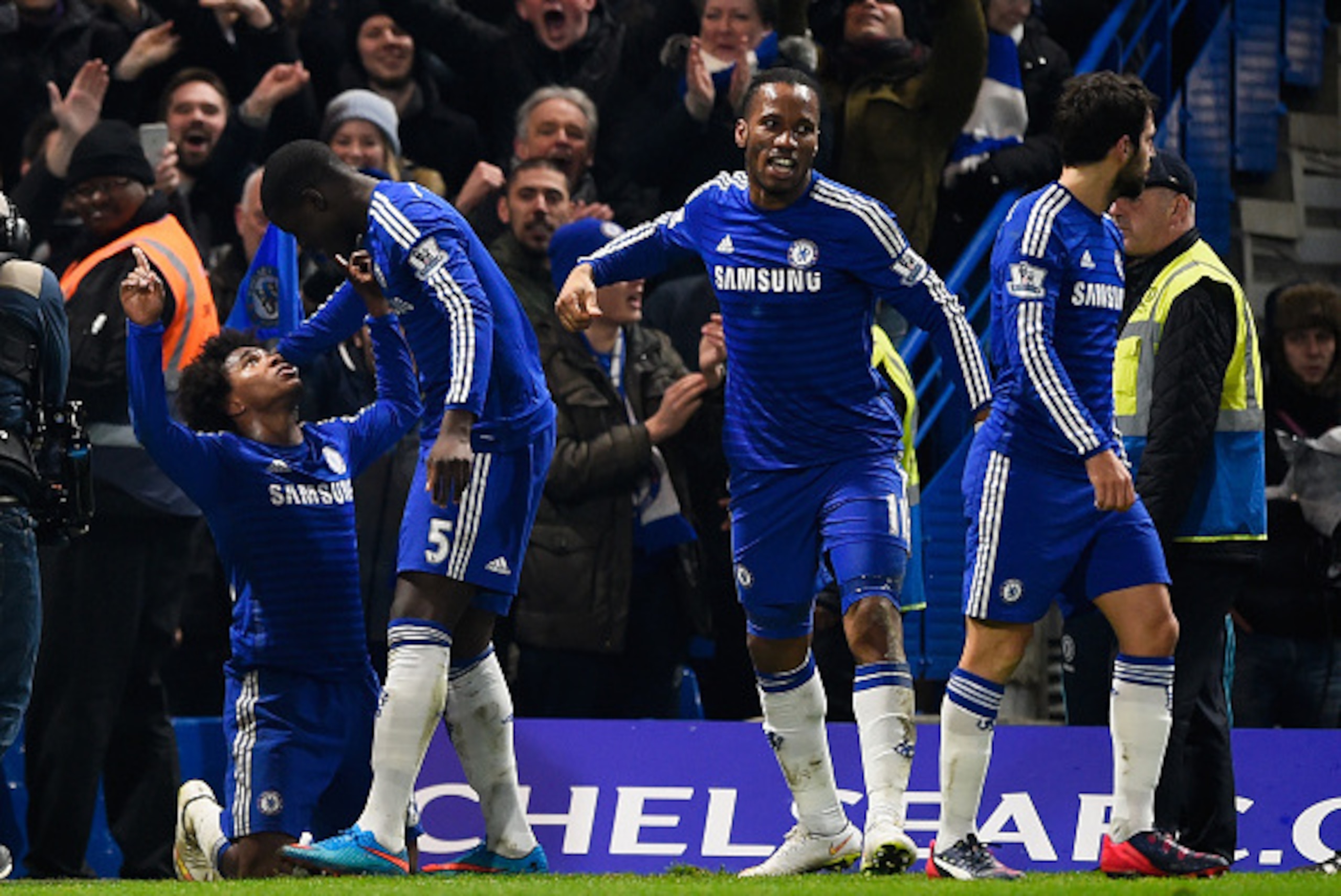 LONDON, ENGLAND - FEBRUARY 11:  Willian of Chelsea (L) celebrates scoring the first goal with Kurt Zouma of Chelsea  during the Barclays Premier League match between Chelsea and Everton at Stamford Bridge on February 11, 2015 in London, England.  (Photo b