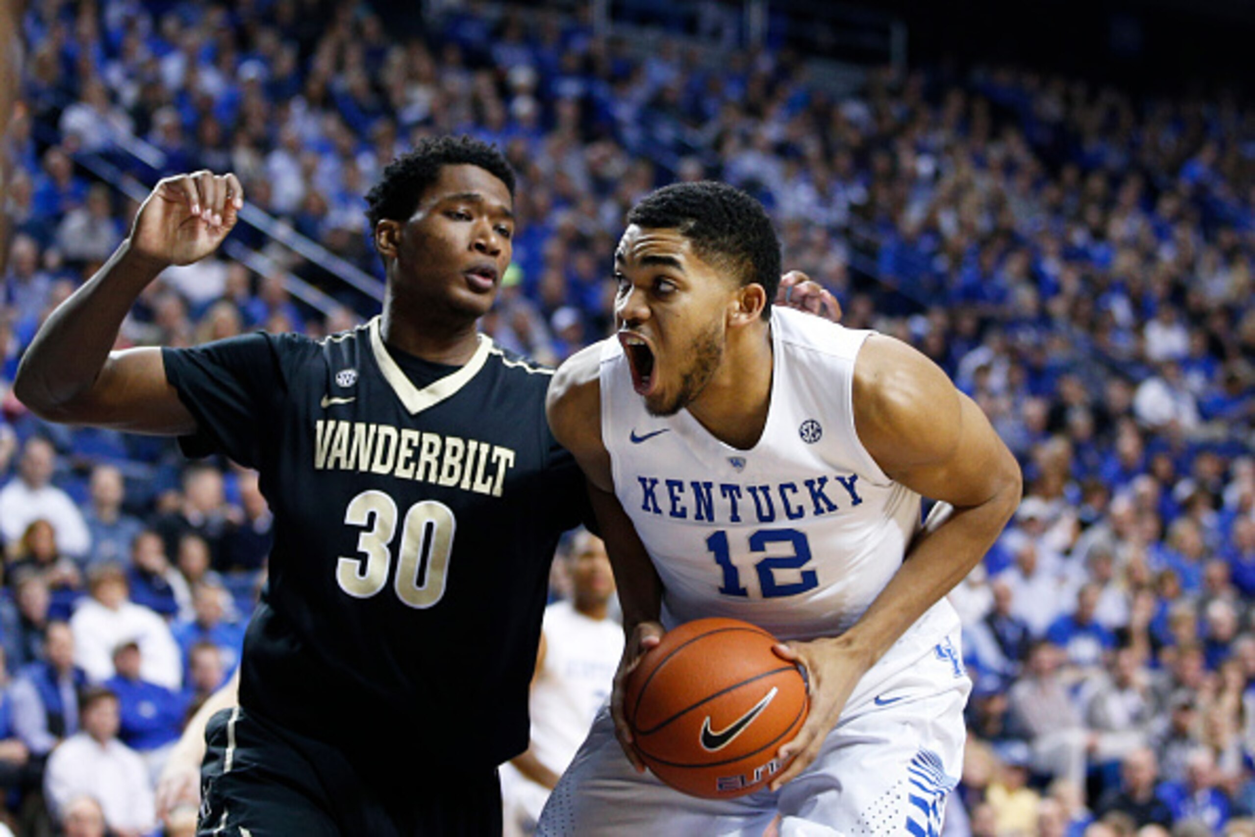 LEXINGTON, KY - JANUARY 20: Karl-Anthony Towns #12 of the Kentucky Wildcats goes to the basket against Damian Jones #30 of the Vanderbilt Commodores in the first half of the game at Rupp Arena on January 20, 2015 in Lexington, Kentucky. (Photo by Joe Robb