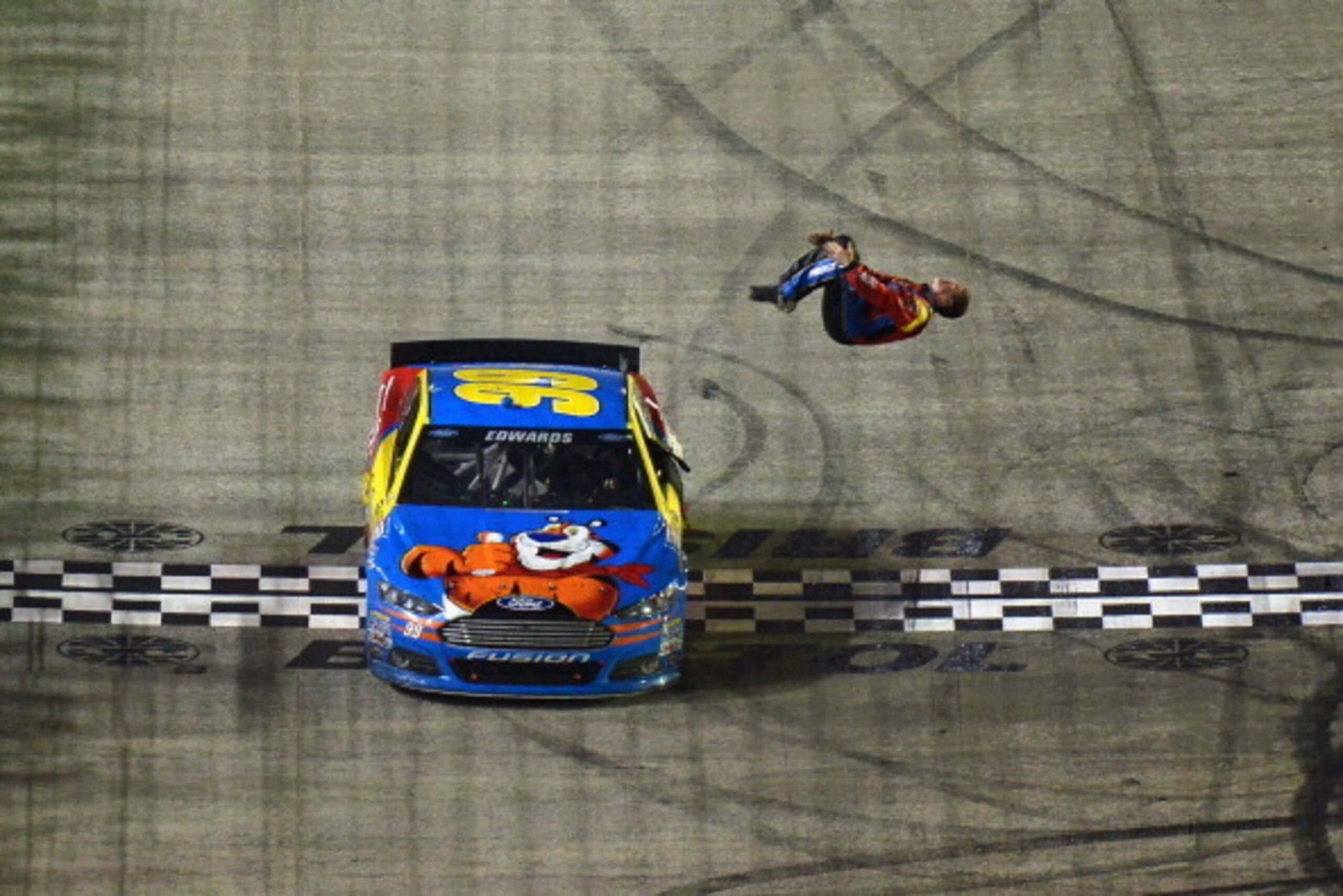 BRISTOL, TN - MARCH 16: Carl Edwards, driver of the #99 Kellogg's/Frosted Flakes Ford, celebrates with a backflip after winning the NASCAR Sprint Cup Series Food City 500 at Bristol Motor Speedway on March 16, 2014 in Bristol, Tennessee.  (Photo by Drew H