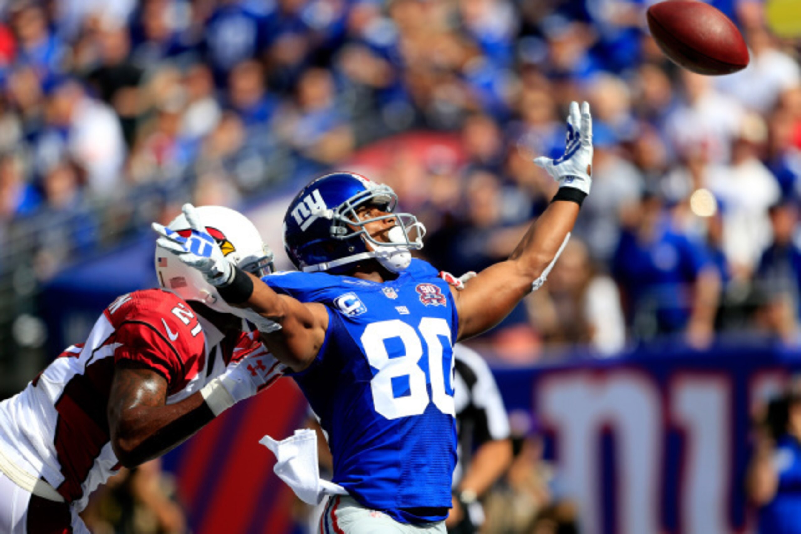 EAST RUTHERFORD, NJ - SEPTEMBER 14: Wide receiver Victor Cruz #80 of the New York Giants tries to make a catch as cornerback Patrick Peterson #21 of the Arizona Cardinals defends during a game at MetLife Stadium on September 14, 2014 in East Rutherford, N