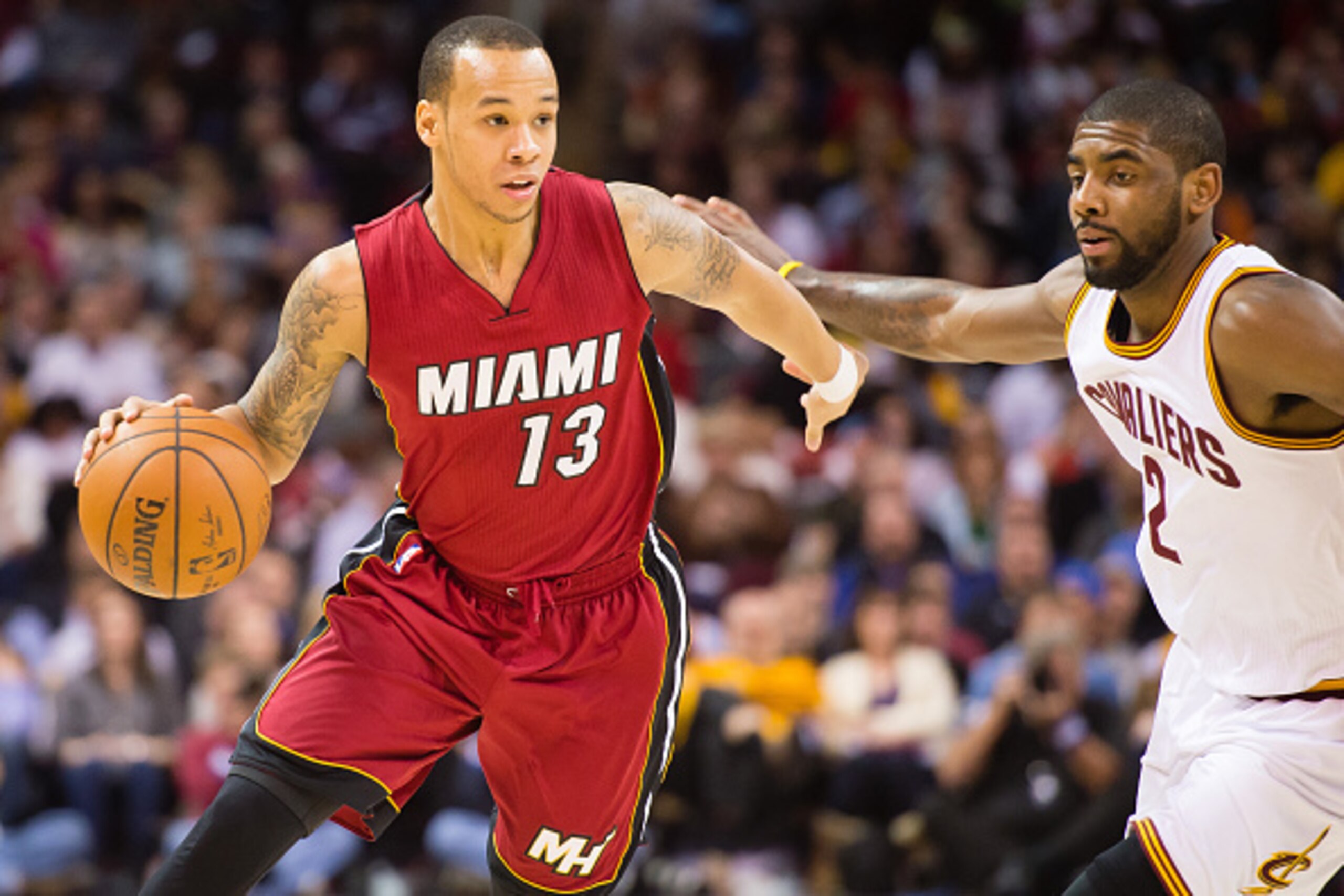 CLEVELAND, OH - FEBRUARY 11: Shabazz Napier #13 of the Miami Heat drives around Kyrie Irving #2 of the Cleveland Cavaliers during the first half at Quicken Loans Arena on February 11, 2015 in Cleveland, Ohio. NOTE TO USER: User expressly acknowledges and 