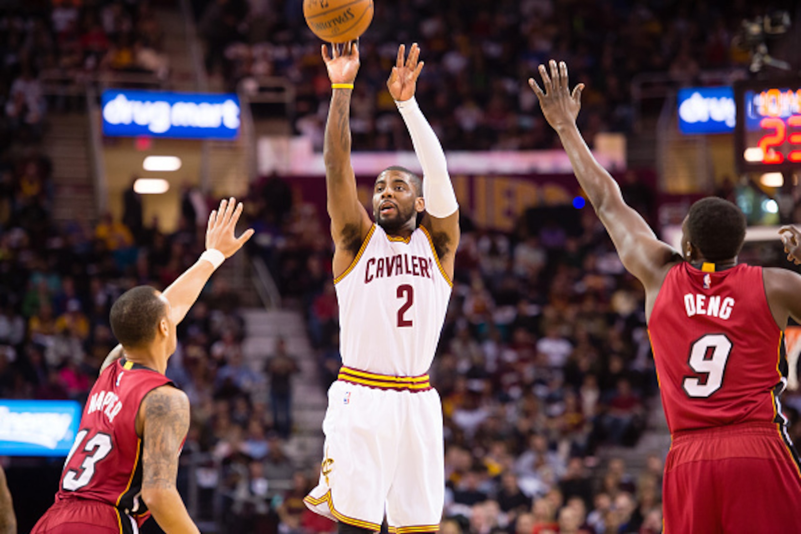 CLEVELAND, OH - FEBRUARY 11: Shabazz Napier #13 and Luol Deng #9 of the Miami Heat try to stop Kyrie Irving #2 of the Cleveland Cavaliers during the first half at Quicken Loans Arena on February 11, 2015 in Cleveland, Ohio. NOTE TO USER: User expressly ac