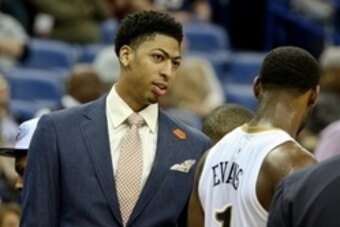 Feb 9, 2015; New Orleans, LA, USA; New Orleans Pelicans forward Anthony Davis out with a sprained shoulder talks with guard Tyreke Evans (1) during the third quarter of a game against the Utah Jazz at the Smoothie King Center. The Jazz defeated the Pelica
