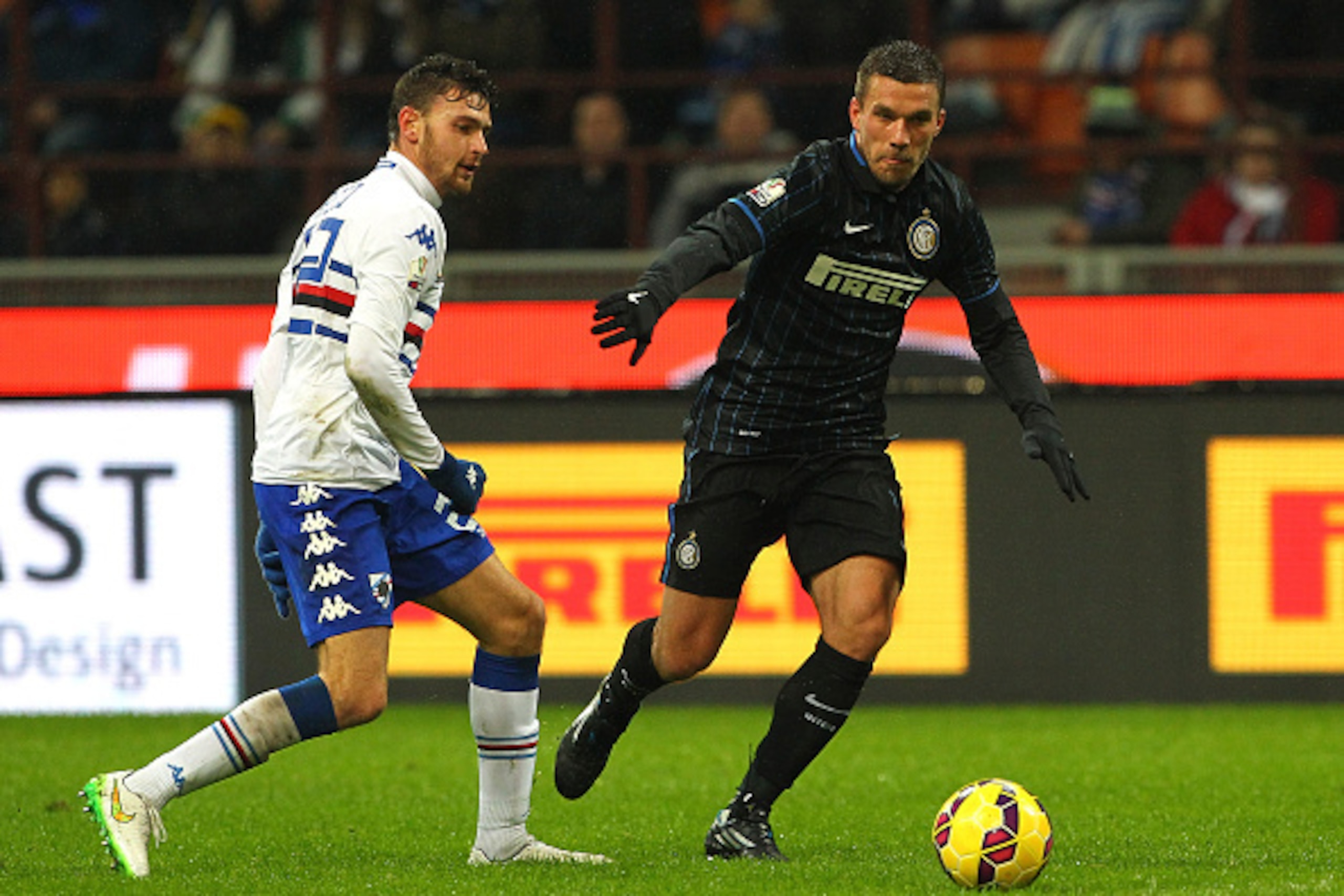 MILAN, ITALY - JANUARY 21:  Lukas Podolski (R) of FC Internazionale Milano is challenged by with Luca Rizzo (L) of UC Sampdoria during the TIM Cup match between FC Internazionale Milano and UC Sampdoria at Stadio Giuseppe Meazza on January 21, 2015 in Mil