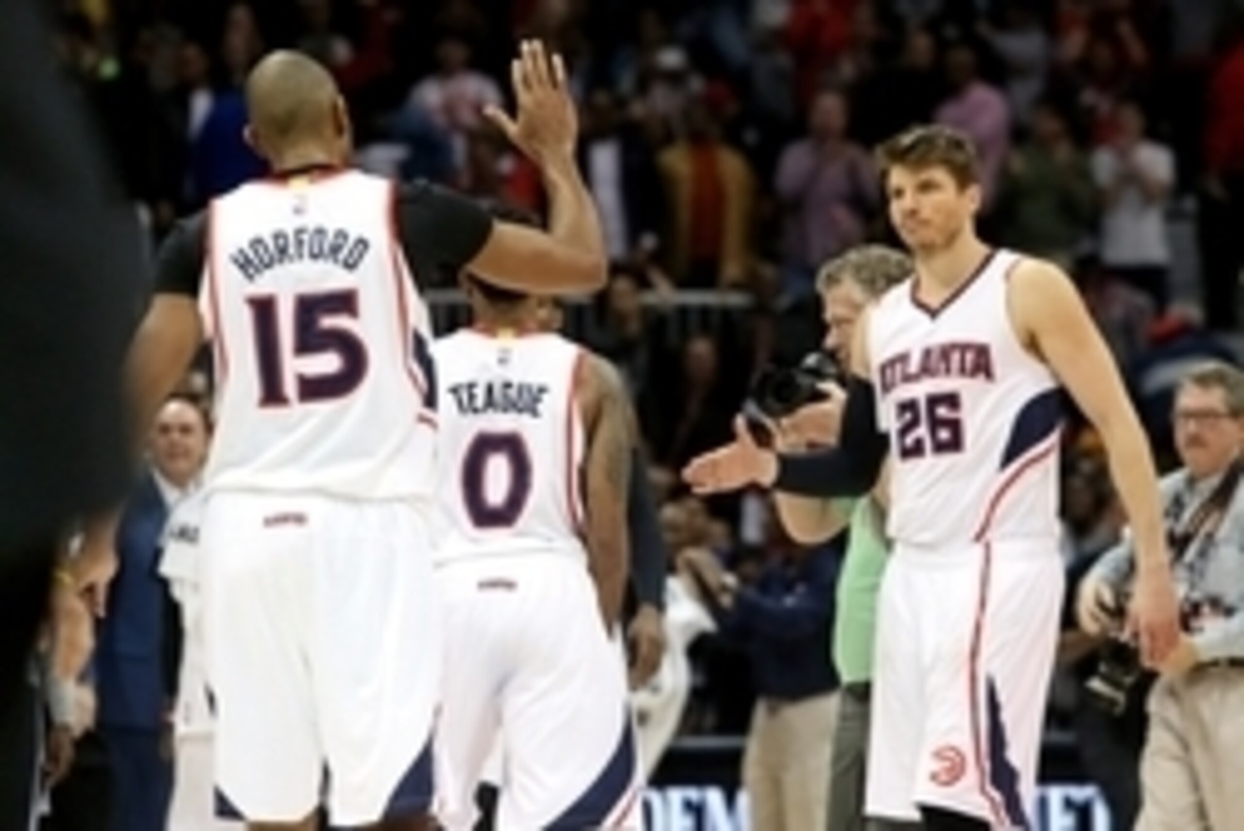 Feb 6, 2015; Atlanta, GA, USA; Atlanta Hawks center Al Horford (15) and guard Kyle Korver (26) celebrate their win over the Golden State Warriors at Philips Arena. The Hawks won 124-116. Mandatory Credit: Jason Getz-USA TODAY Sports