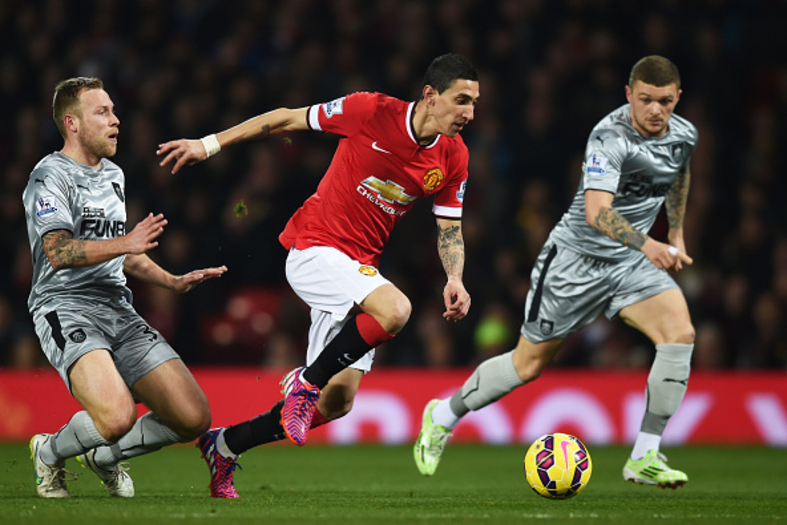 MANCHESTER, ENGLAND - FEBRUARY 11: Angel Di Maria of Manchester United skips away from Scott Arfield of Burnley during the Barclays Premier League match between Manchester United and Burnley at Old Trafford on February 11, 2015 in Manchester, England.  (P
