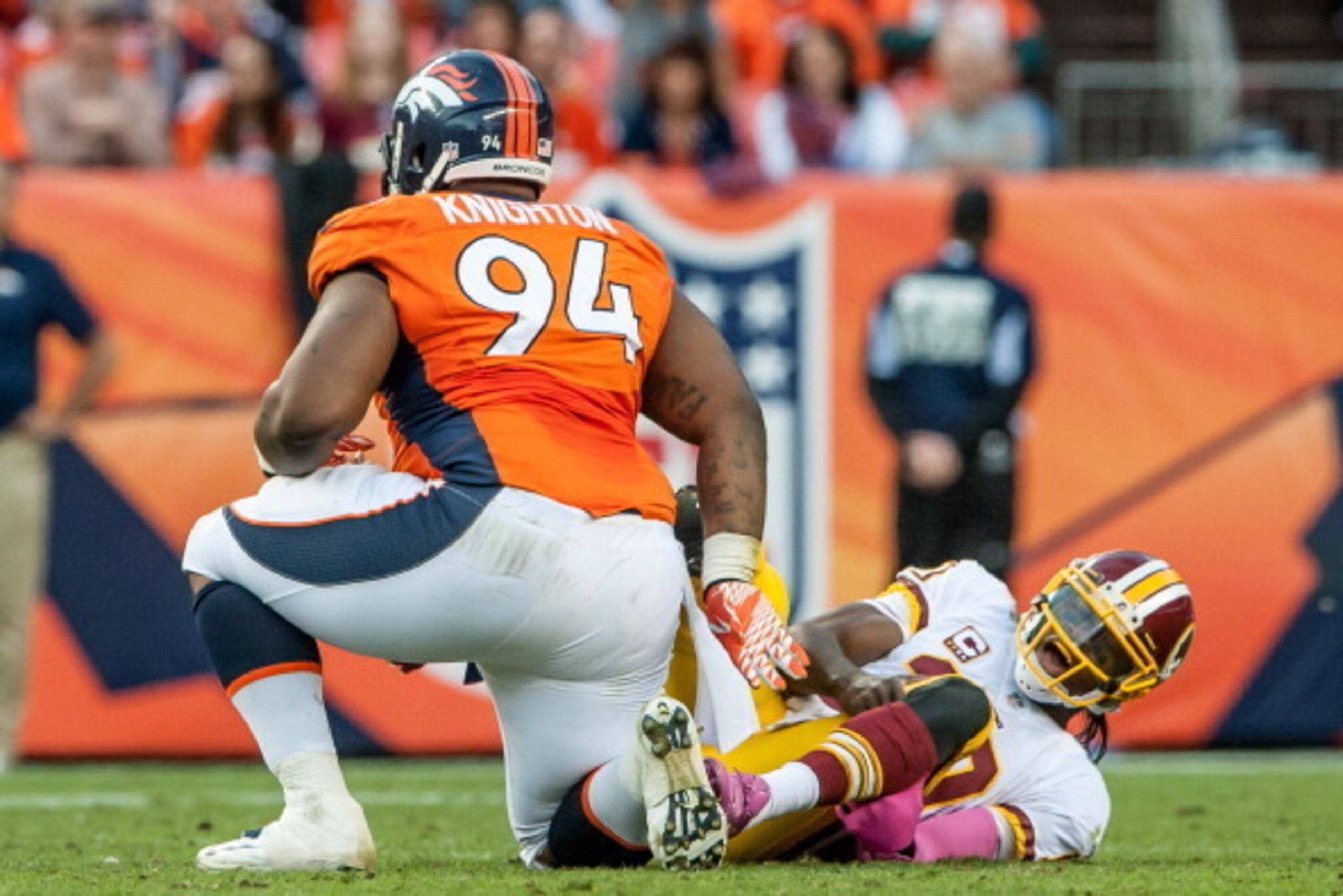 DENVER, CO - OCTOBER 27:  Quarterback Robert Griffin III #10 of the Washington Redskins reacts after being hit by defensive tackle Terrance Knighton #94 of the Denver Broncos during a game at Sports Authority Field Field at Mile High on October 27, 2013 i