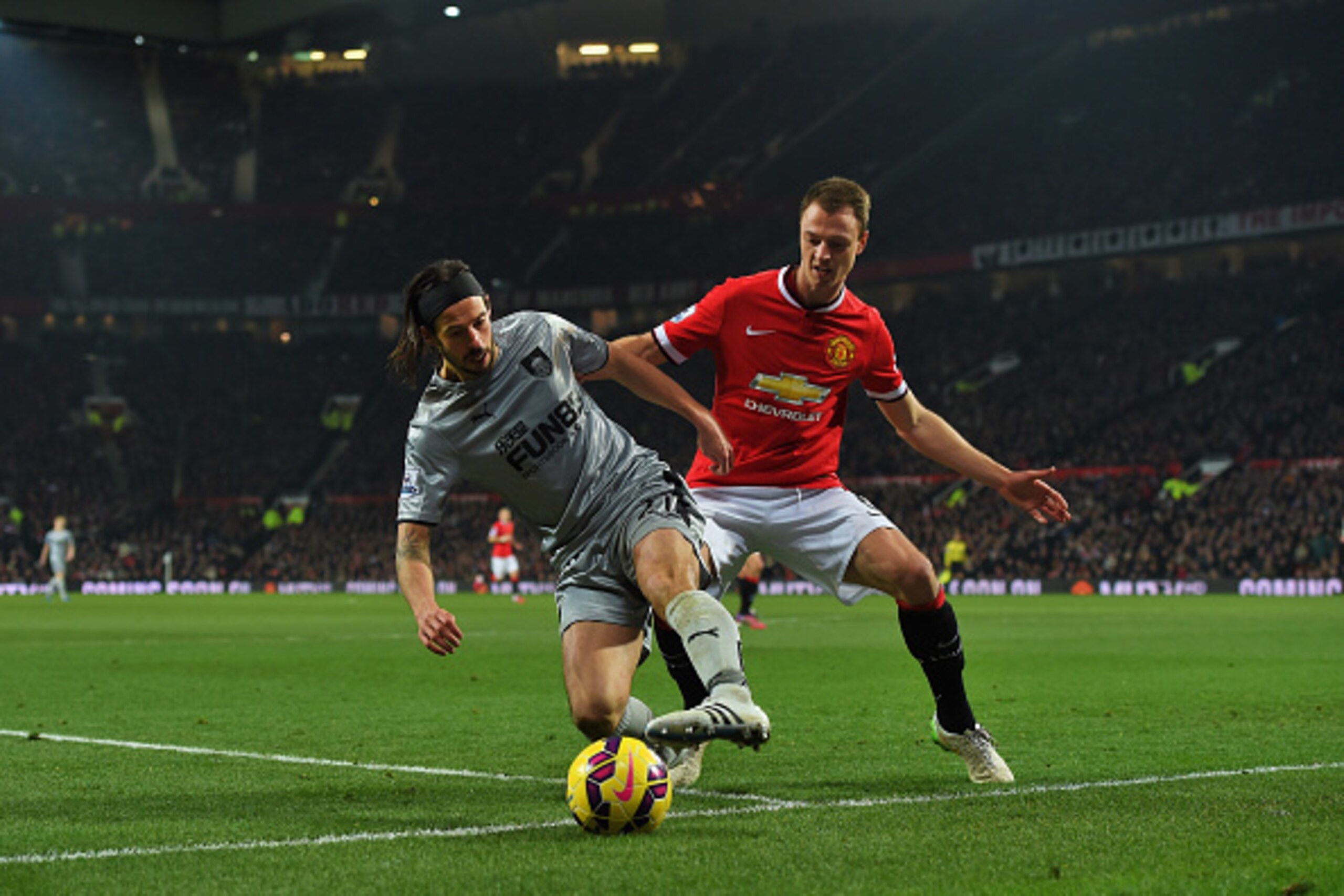 MANCHESTER, ENGLAND - FEBRUARY 11: George Boyd of Burnley is closed down by Jonny Evans of Manchester United during the Barclays Premier League match between Manchester United and Burnley at Old Trafford on February 11, 2015 in Manchester, England. (Pho MANCHESTER, ENGLAND - FEBRUARY 11: George Boyd of Burnley is closed down by Jonny Evans of Manchester United during the Barclays Premier League match between Manchester United and Burnley at Old Trafford on February 11, 2015 in Manchester, England. (Pho