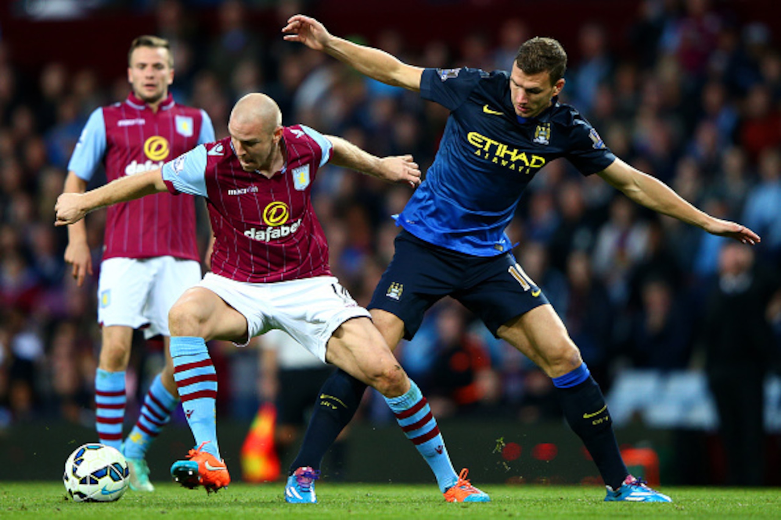 BIRMINGHAM, ENGLAND - OCTOBER 04: Philippe Senderos of Aston Villa battles for the ball with Edin Dzeko of Manchester City during the Barclays Premier League match between Aston Villa and Manchester City at Villa Park on October 4, 2014 in Birmingham, En BIRMINGHAM, ENGLAND - OCTOBER 04: Philippe Senderos of Aston Villa battles for the ball with Edin Dzeko of Manchester City during the Barclays Premier League match between Aston Villa and Manchester City at Villa Park on October 4, 2014 in Birmingham, En
