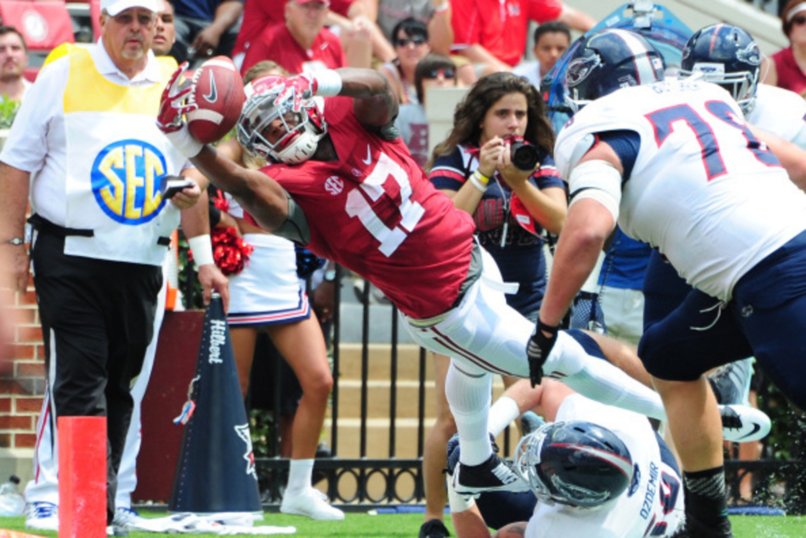 TUSCALOOSA, AL - SEPTEMBER 6: Kenyan Drake #17 of the Alabama Crimson Tide dives just short of the goal line against Nate Ozdemir #50 of the Florida Atlantc Owls at Bryant-Denny Stadium on September 6, 2014 in Tuscaloosa, Alabama. (Photo by Scott Cunningh