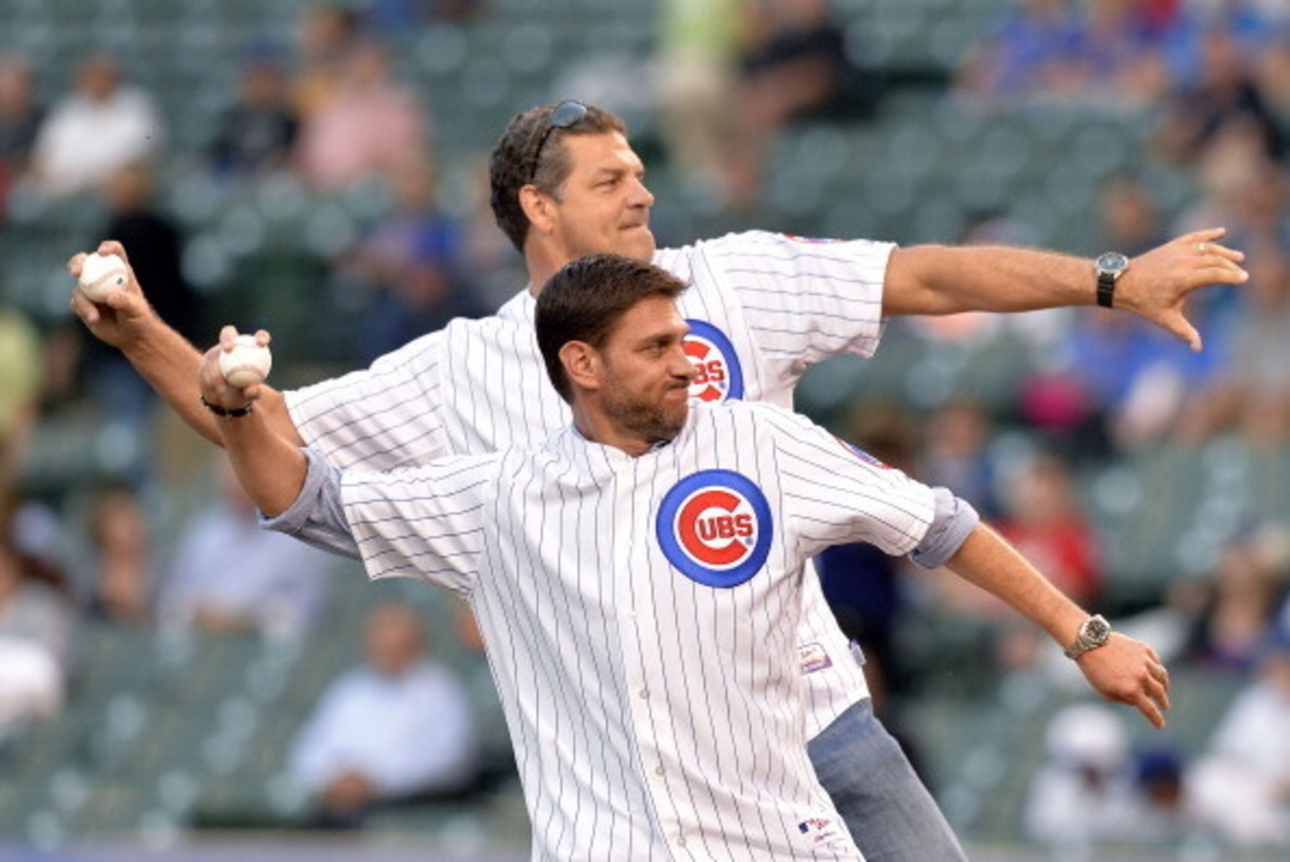 CHICAGO, IL- JULY 29:  ESPN radio hosts Mike Greenberg (R) and Mike Golic throw out ceremonial first pitches before the Chicago Cubs game against the Colorado Rockies on July 29, 2014 at Wrigley Field in Chicago, Illinois.  (Photo by Brian Kersey/Getty Im