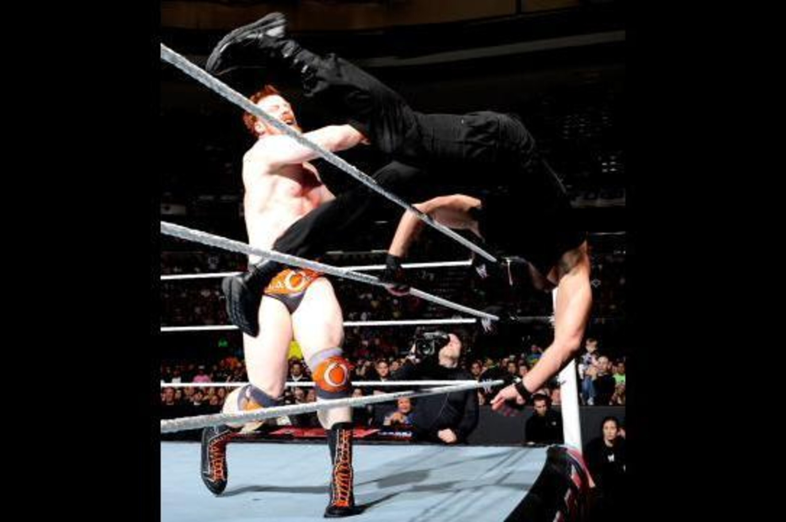 Sheamus throws Dean Ambrose out of the ring.