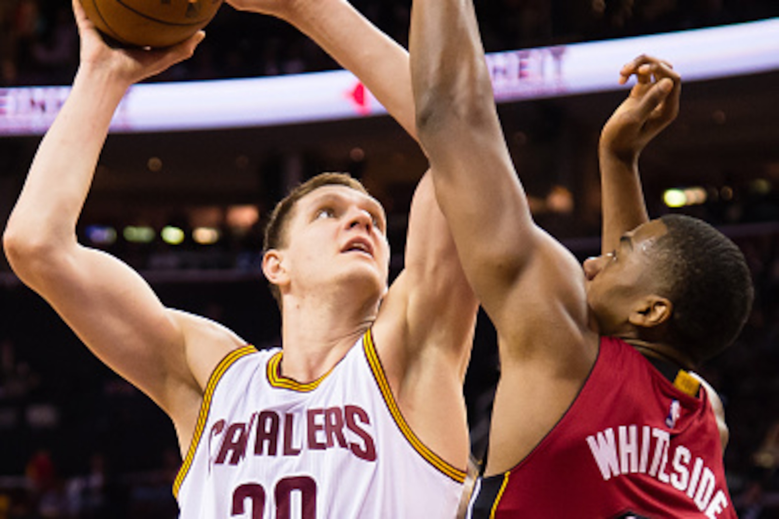 CLEVELAND, OH - FEBRUARY 11: Timofey Mozgov #20 of the Cleveland Cavaliers shoots over Hassan Whiteside #21 of the Miami Heat during the second half at Quicken Loans Arena on February 11, 2015 in Cleveland, Ohio. The Cavaliers defeated the Heat 113-93. NO