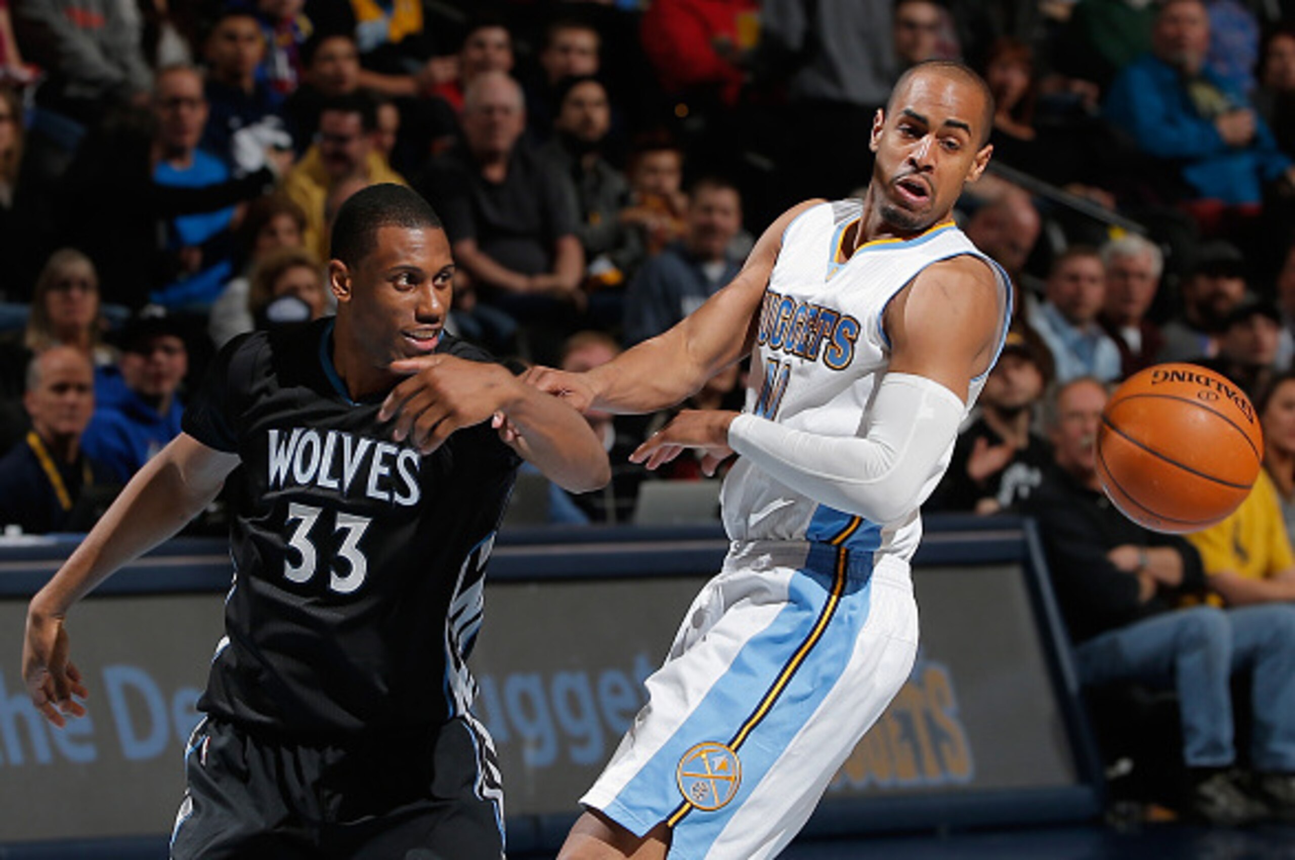 DENVER, CO - JANUARY 17:  Thaddeus Young #33 of the Minnesota Timberwolves and Arron Afflalo #10 of the Denver Nuggets vie for a loose ball at Pepsi Center on January 17, 2015 in Denver, Colorado. The Timberwolves defeated the Nuggets 113-105. NOTE TO USE