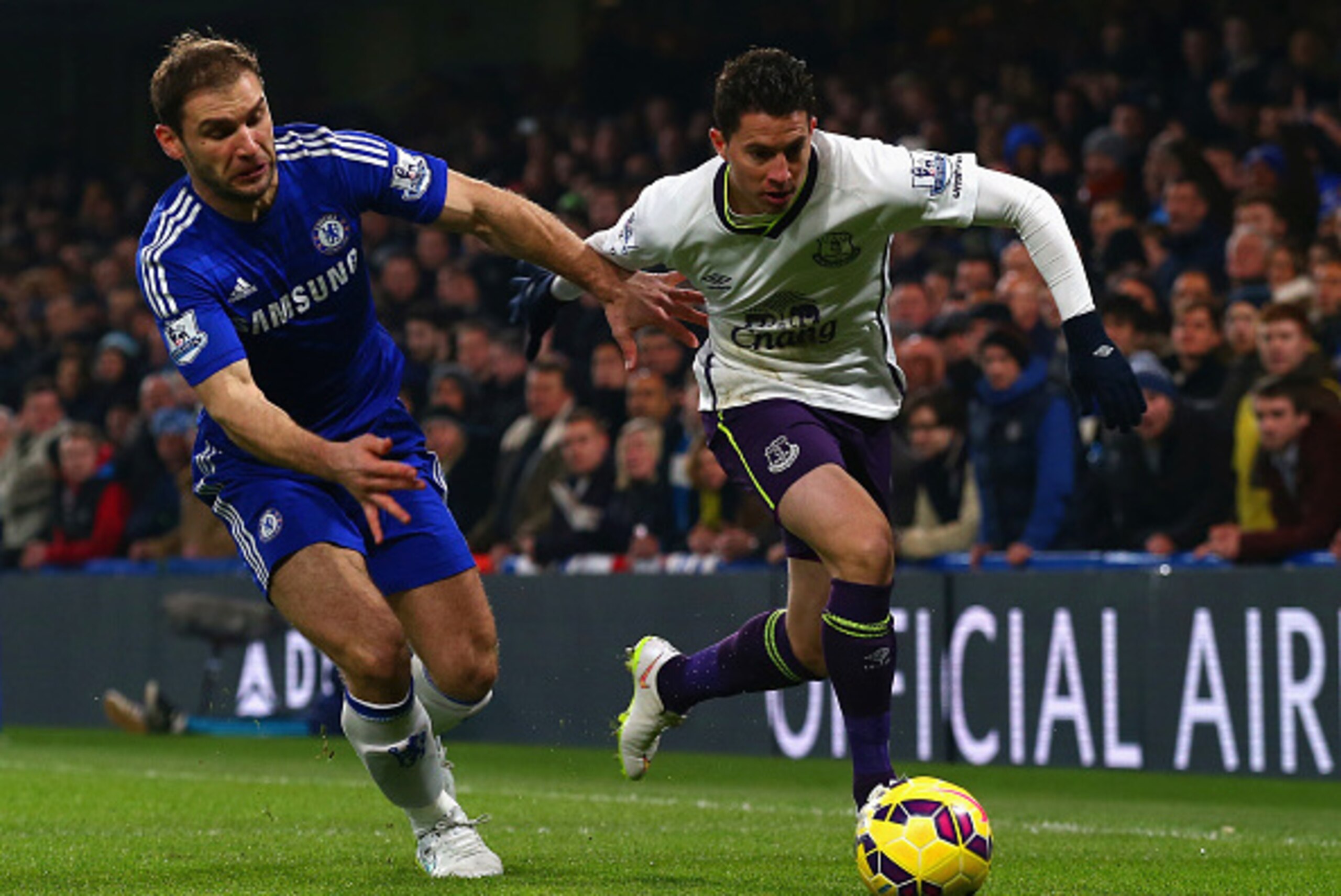LONDON, ENGLAND - FEBRUARY 11:  Branislav Ivanovic of Chelsea and Bryan Oviedo of Everton battle for the ball during the Barclays Premier League match between Chelsea and Everton at Stamford Bridge on February 11, 2015 in London, England.  (Photo by Clive