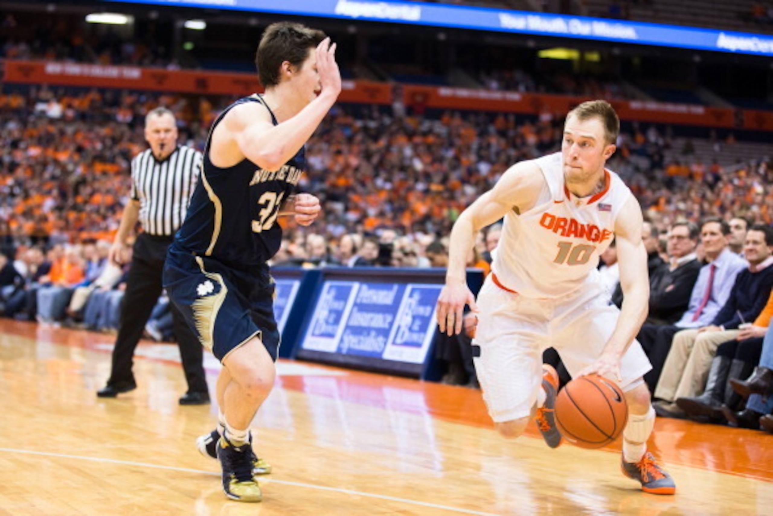 SYRACUSE, NY - FEBRUARY 3:  Steve Vasturia #32 of the Notre Dame Fighting Irish defends against Trevor Cooney #10 of the Syracuse Orange as he drives towards the basket during the second half on February 3, 2014 at The Carrier Dome in Syracuse, New York. 