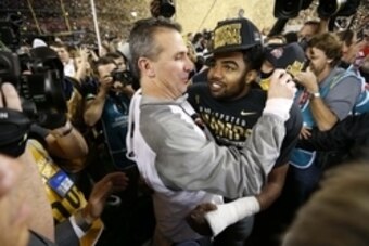 Jan 12, 2015; Arlington, TX, USA; Ohio State Buckeyes head coach Urban Meyer (left) greets running back Ezekiel Elliott (right) after defeating the Oregon Ducks in the 2015 CFP National Championship Game at AT&T Stadium. Mandatory Credit: Matthew Emmons-U