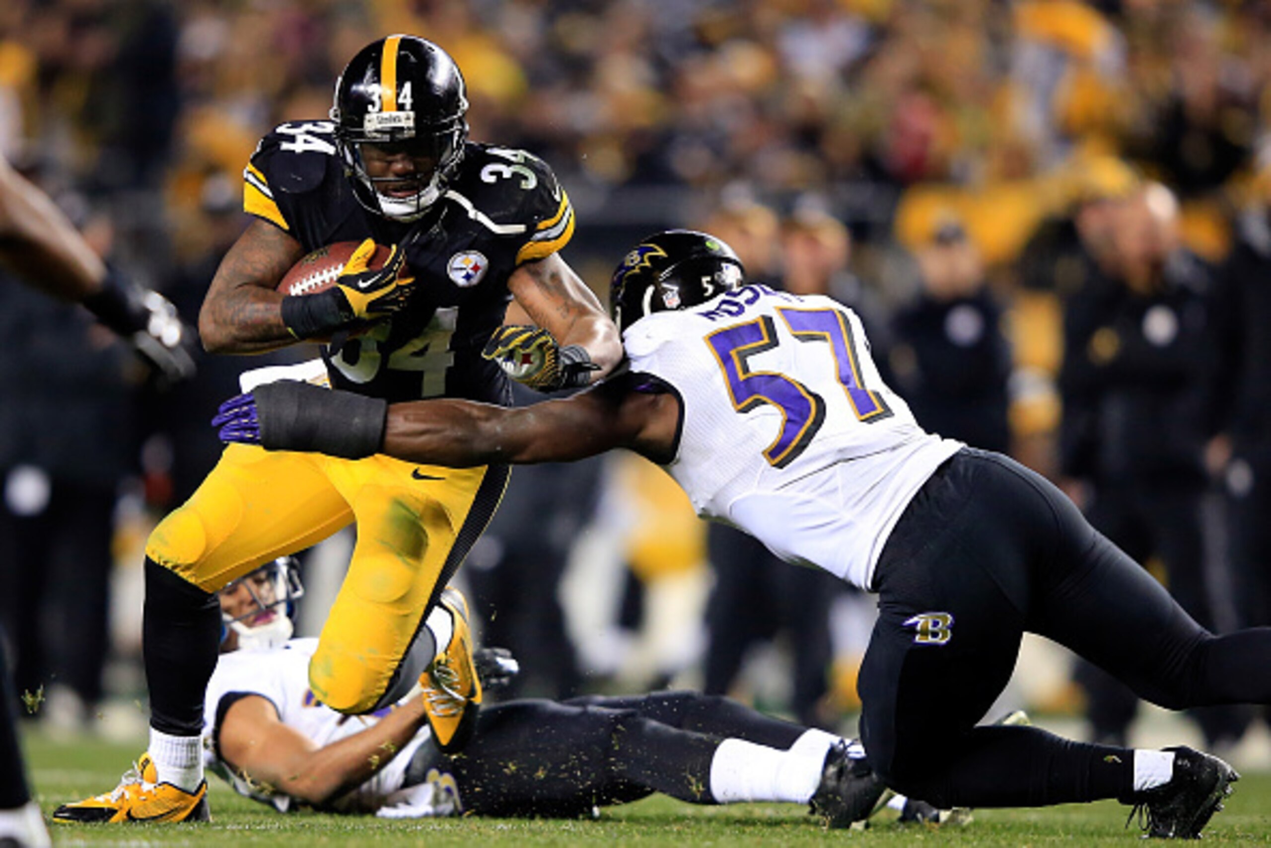 PITTSBURGH, PA - JANUARY 03: Ben Tate #34 of the Pittsburgh Steelers is tackled  C.J. Mosley #57 of the Baltimore Ravens during their AFC Wild Card game at Heinz Field on January 3, 2015 in Pittsburgh, Pennsylvania.  (Photo by Jamie Squire/Getty Images)