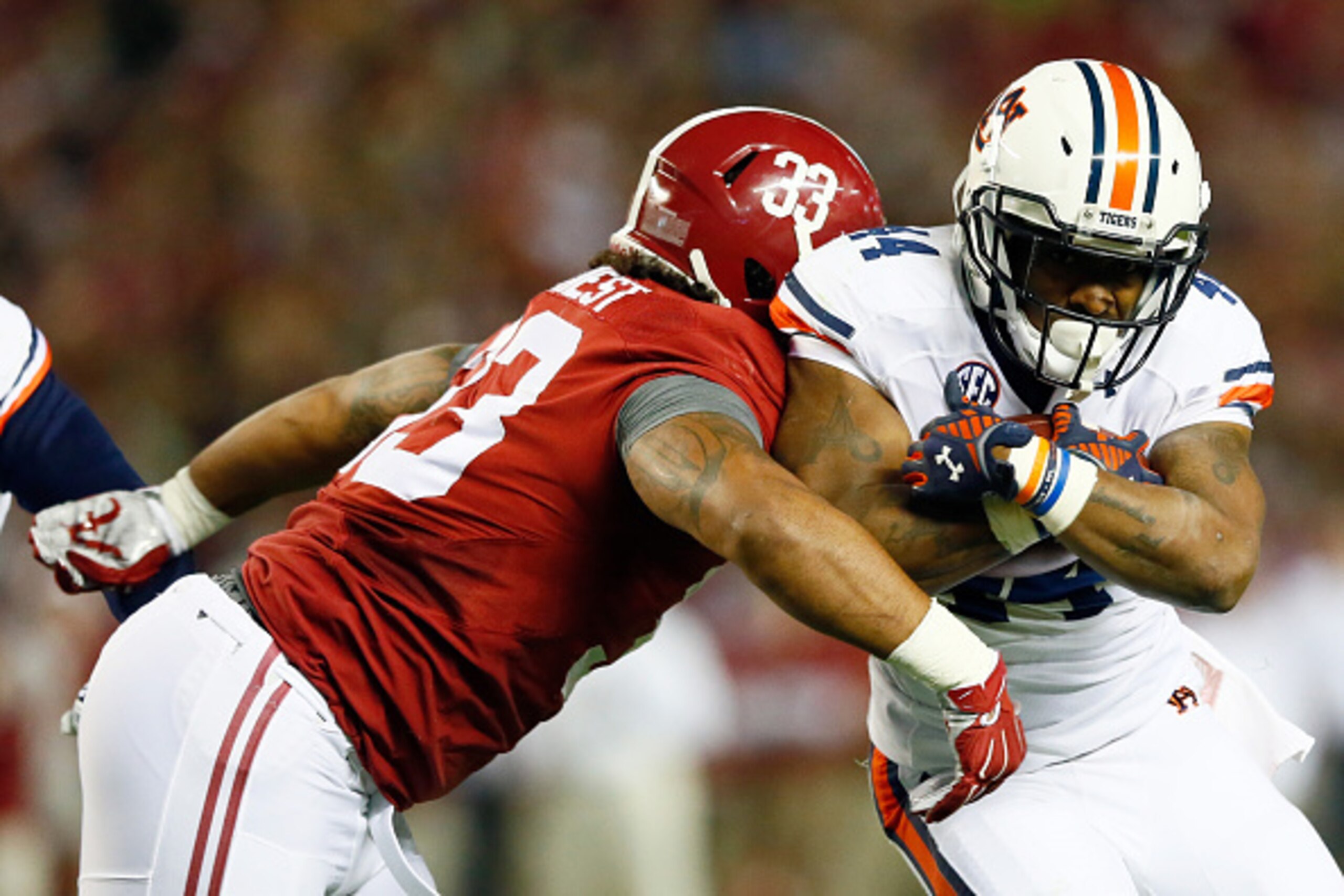TUSCALOOSA, AL - NOVEMBER 29:  Cameron Artis-Payne #44 of the Auburn Tigers runs the ball in the first quarter against Trey DePriest #33 of the Alabama Crimson Tide during the Iron Bowl at Bryant-Denny Stadium on November 29, 2014 in Tuscaloosa, Alabama. 