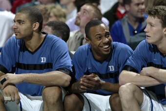 10 Mar 2002: Jason Williams #22 smiles as Carlos Boozer #4  and Mike Dunleavy #22 of Duke observes the ACC Tournament championship game against North Carolina State at the Charlotte Coliseum in Charlotte, North Carolina. Duke defeated North Carolina State