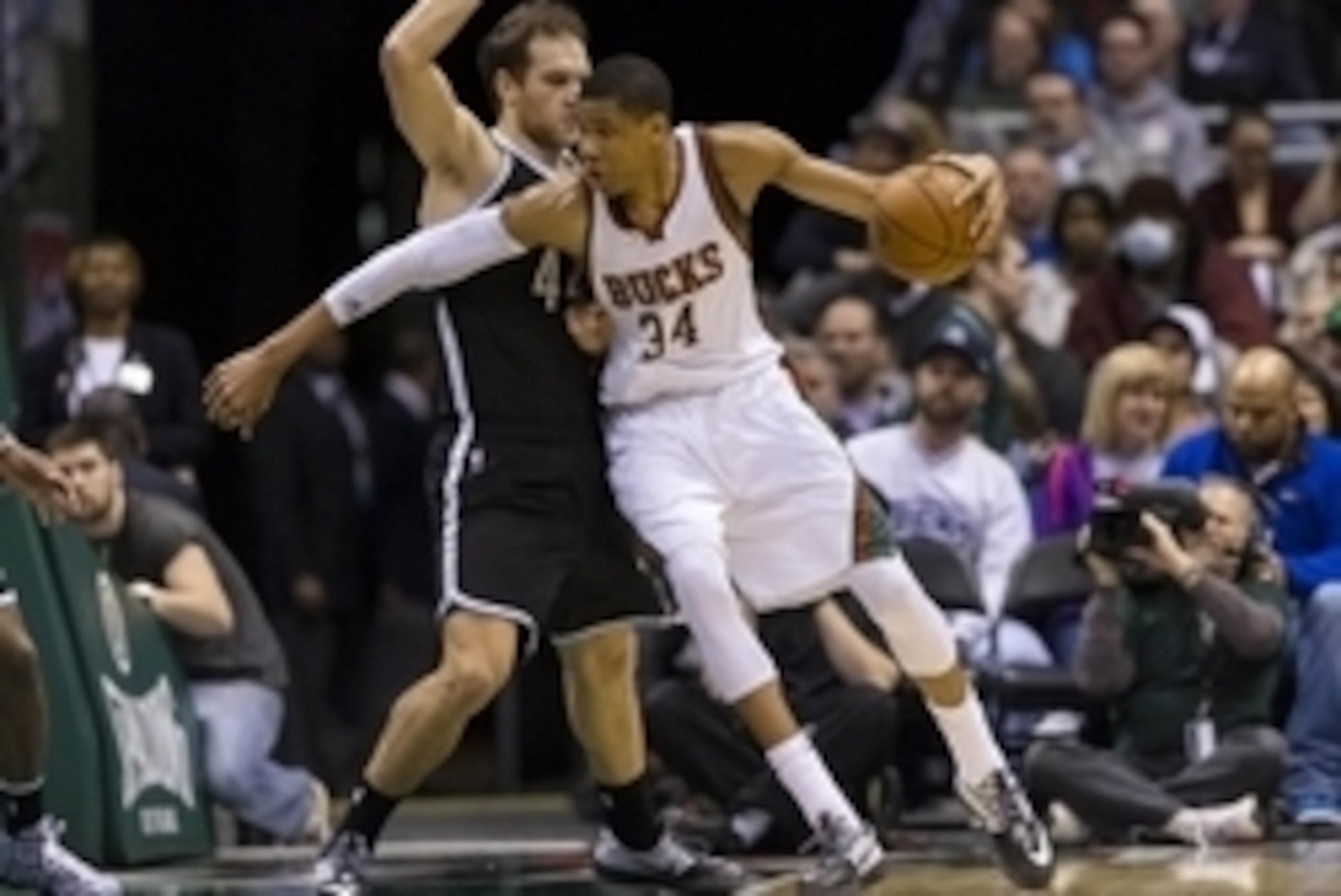 Feb 9, 2015; Milwaukee, WI, USA; Milwaukee Bucks forward Giannis Antetokounmpo (34) dribbles against Brooklyn Nets guard Bojan Bogdanovic (44) during the second quarter at BMO Harris Bradley Center. Mandatory Credit: Jeff Hanisch-USA TODAY Sports