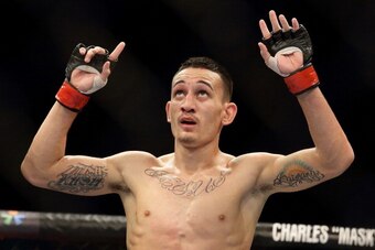 SINGAPORE - JANUARY 04:  Max Holloway reacts after defeating Will Chope during their UFC Fight Night Singapore featherweight bout at Marina Bay Sands on January 4, 2014 in Singapore.  (Photo by Suhaimi Abdullah/Getty Images)