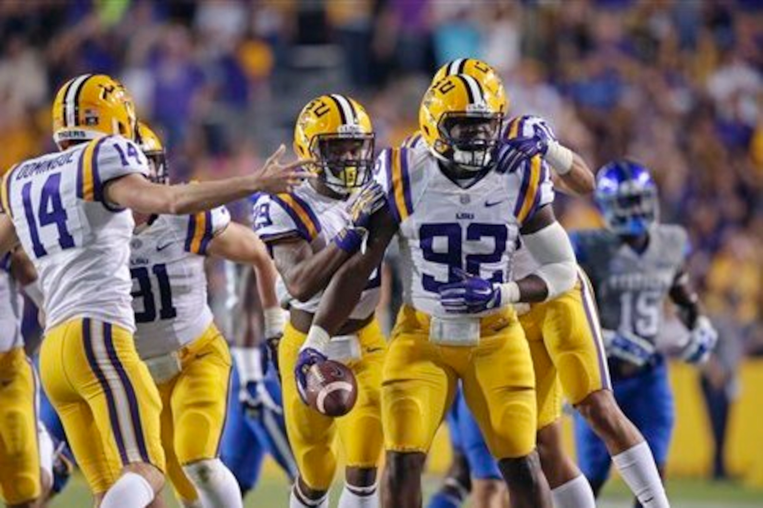 LSU defensive end Lewis Neal (No. 92) celebrates with teammates.