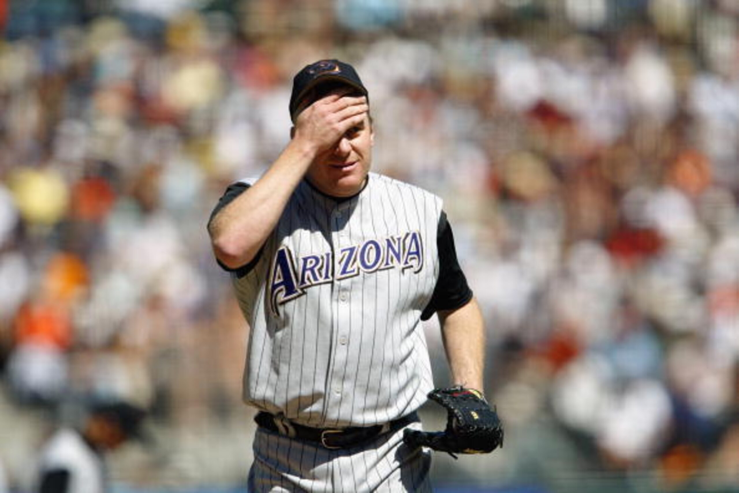 SAN FRANCISCO - SEPTEMBER 6 :  Pitcher Curt Schilling #38 of the Arizona Diamondbacks wipes his forhead during the game against the San Francisco Giants at Pacific Bell Park on September 6, 2003 in San Francisco, California.  The Giants defeated the Diamo