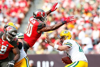 TAMPA, FL - DECEMBER 21:  Michael Johnson #90 of the Tampa Bay Buccaneers pressures Aaron Rodgers #12 of the Green Bay Packers and forces a fumble at Raymond James Stadium on December 21, 2014 in Tampa, Florida.  (Photo by Kevin C. Cox/Getty Images)