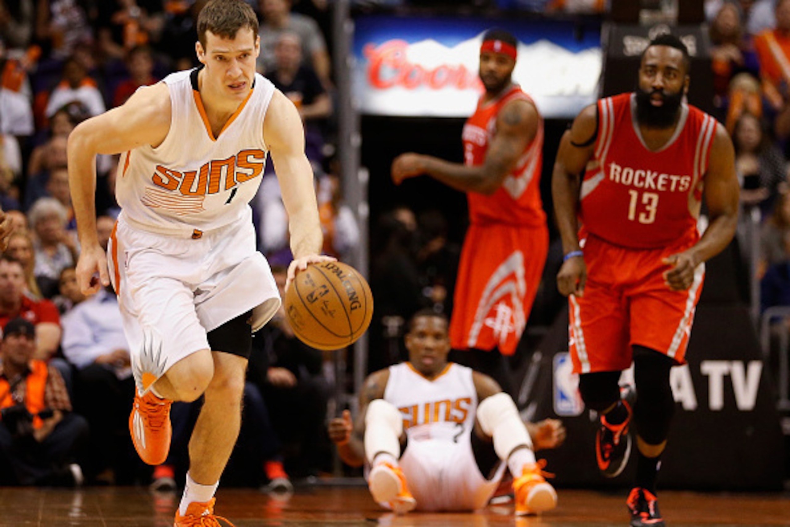 PHOENIX, AZ - FEBRUARY 10:  Goran Dragic #1 of the Phoenix Suns moves the ball upcourt after a turnover from James Harden #13 of the Houston Rockets during the second half of the NBA game at US Airways Center on February 10, 2015 in Phoenix, Arizona. The 