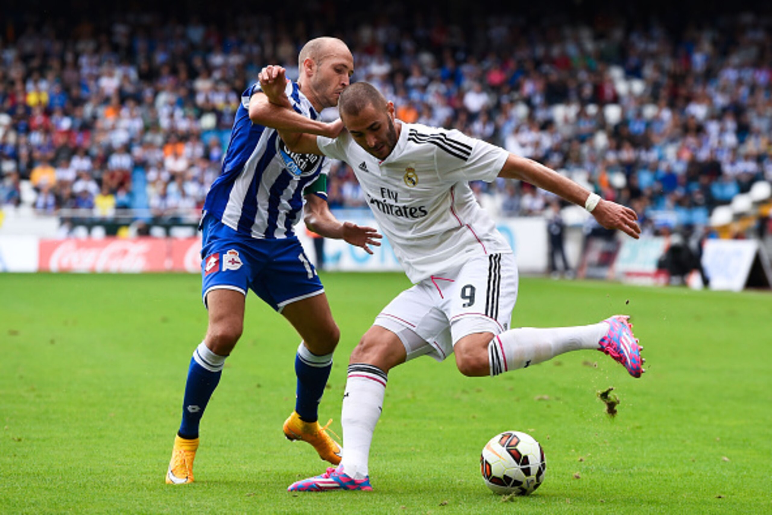 LA CORUNA, SPAIN - SEPTEMBER 20:  Karim Benzema of Real Madrid CF competes for the ball with Laure Sanabria of RC Deportivo La Coruna during the La Liga match between RC Deportivo La Coruna and Real Madrid CF at Riazor Stadium on September 20, 2014 in La 