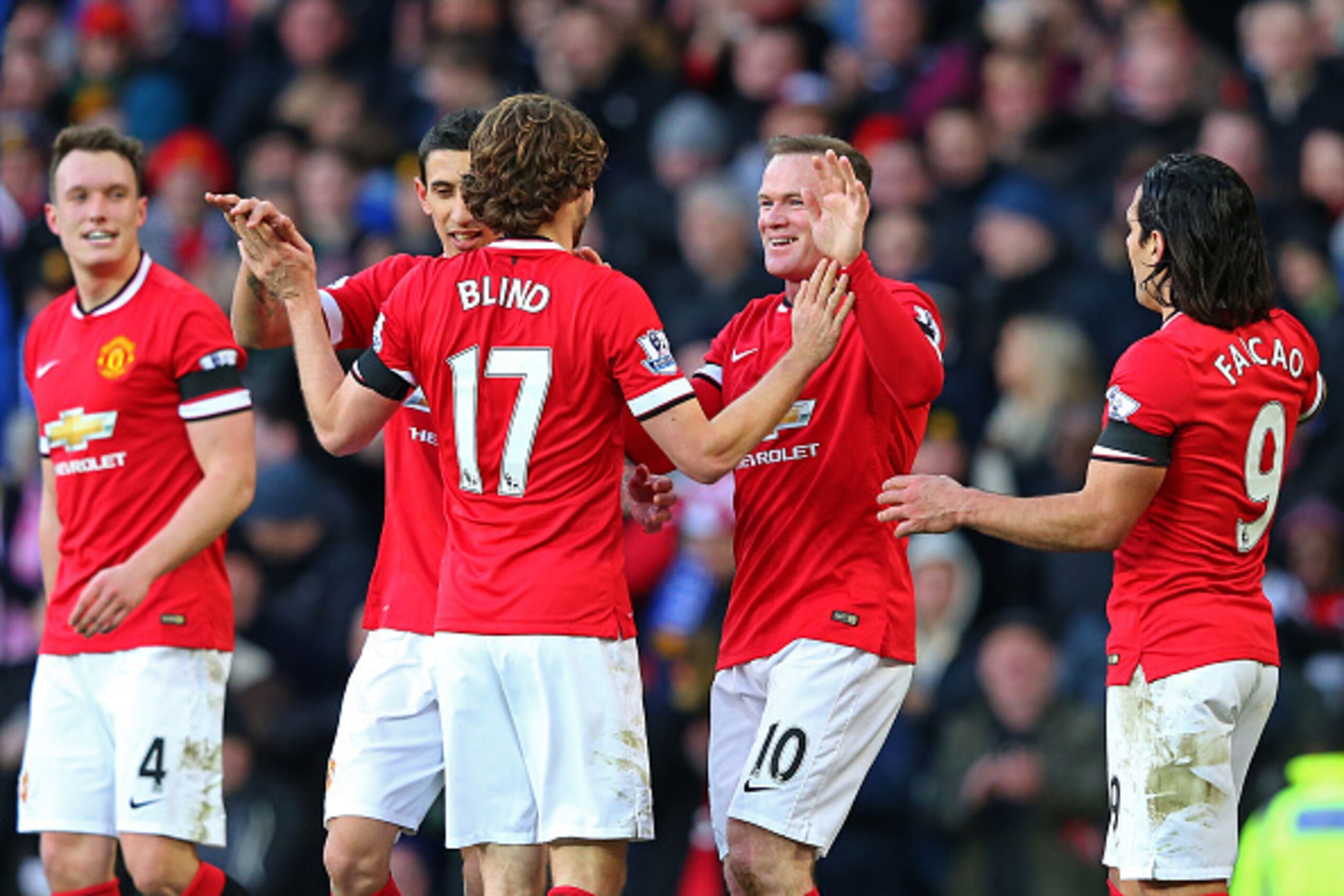 MANCHESTER, ENGLAND - JANUARY 31:  Daley Blind #17 of Manchester United and Wayne Rooney of Manchester United celebrate after their interplay led to their team's third goal during the Barclays Premier League match between Manchester United and Leicester C