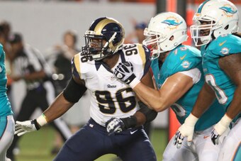 MIAMI GARDENS, FL - AUGUST 28:  Defensive end Michael Sam #96 of the St. Louis Rams tries to elude Nate Garner #75 of the Miami Dolphins in the second quarter at Sun Life Stadium on August 28, 2014 in Miami Gardens, Florida.  (Photo by Marc Serota/Getty I