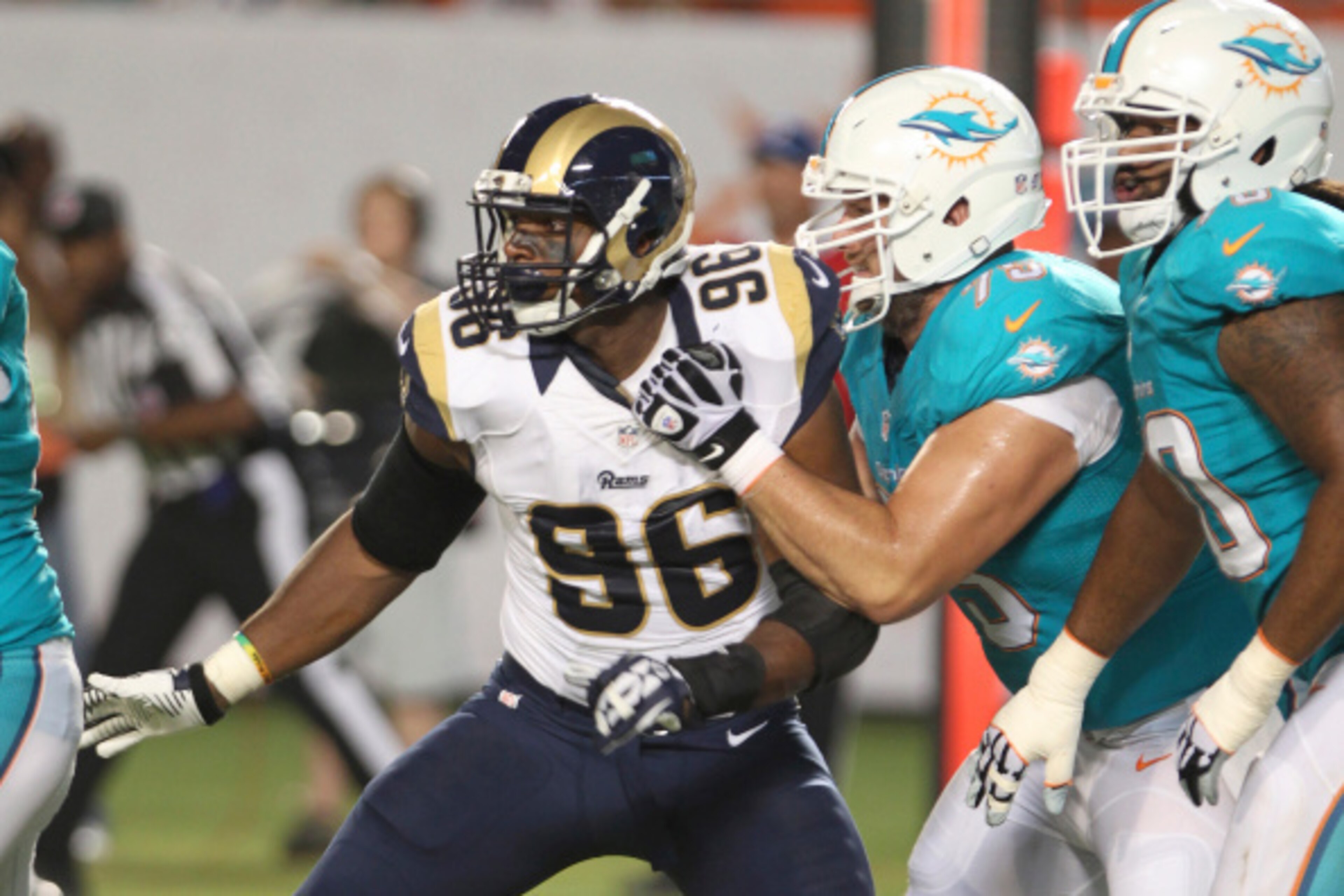 MIAMI GARDENS, FL - AUGUST 28:  Defensive end Michael Sam #96 of the St. Louis Rams tries to elude Nate Garner #75 of the Miami Dolphins in the second quarter at Sun Life Stadium on August 28, 2014 in Miami Gardens, Florida.  (Photo by Marc Serota/Getty I