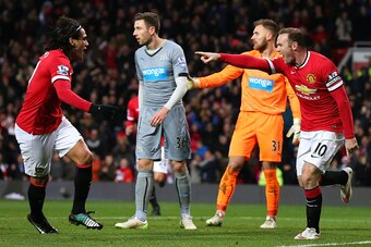 MANCHESTER, ENGLAND - DECEMBER 26:  Wayne Rooney of Manchester United celebrates scoring the first goal with team-mate Radamel Falcao (L) during the Barclays Premier League match between Manchester United and Newcastle United at Old Trafford on December 2