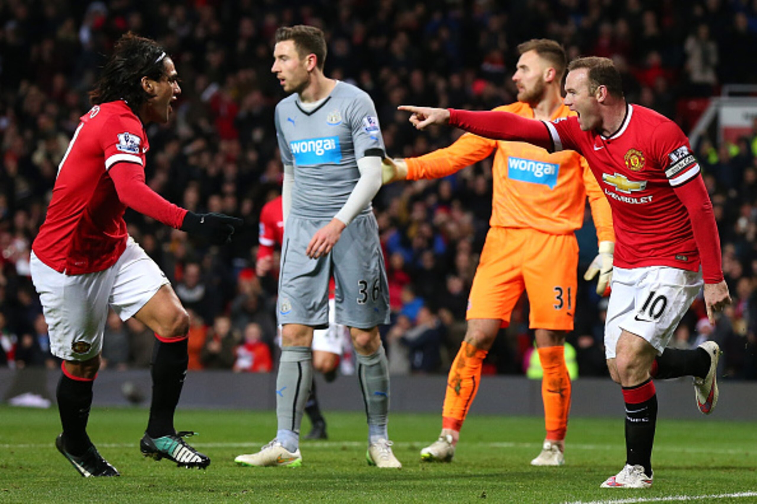 MANCHESTER, ENGLAND - DECEMBER 26:  Wayne Rooney of Manchester United celebrates scoring the first goal with team-mate Radamel Falcao (L) during the Barclays Premier League match between Manchester United and Newcastle United at Old Trafford on December 2