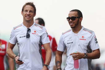 NOIDA, INDIA - OCTOBER 26:  (L-R) Jenson Button of Great Britain and McLaren and Lewis Hamilton of Great Britain and McLaren walk in the paddock following practice for the Indian Formula One Grand Prix at Buddh International Circuit on October 26, 2012 in
