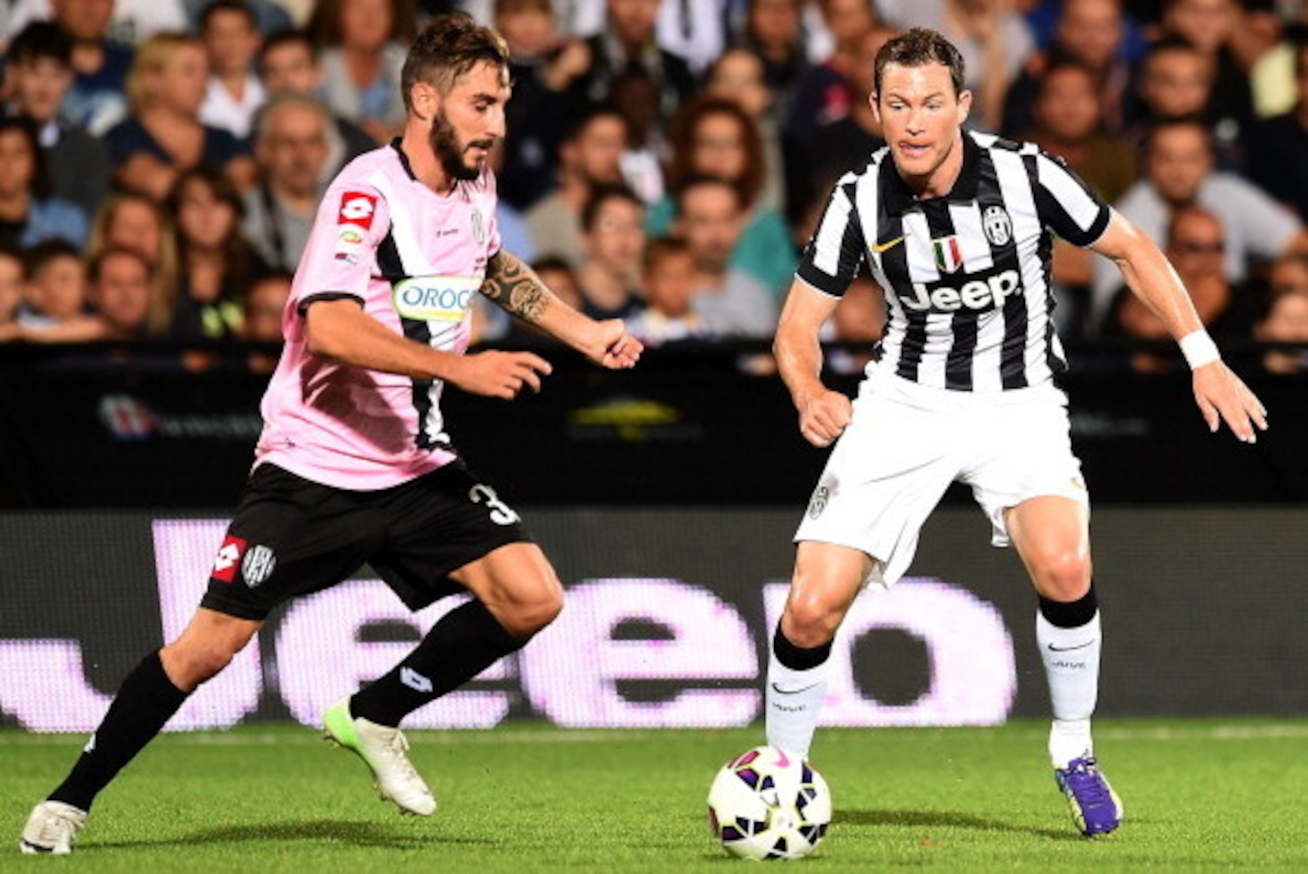 CESENA, ITALY - JULY 30:  Francesco Renzetti of Cesena and Stephan Lichtsteiner of Juventus in action during the pre-season friendly match between AC Cesena and Juventus FC at Dino Manuzzi Stadium on July 30, 2014 in Cesena, Italy.  (Photo by Giuseppe Bel