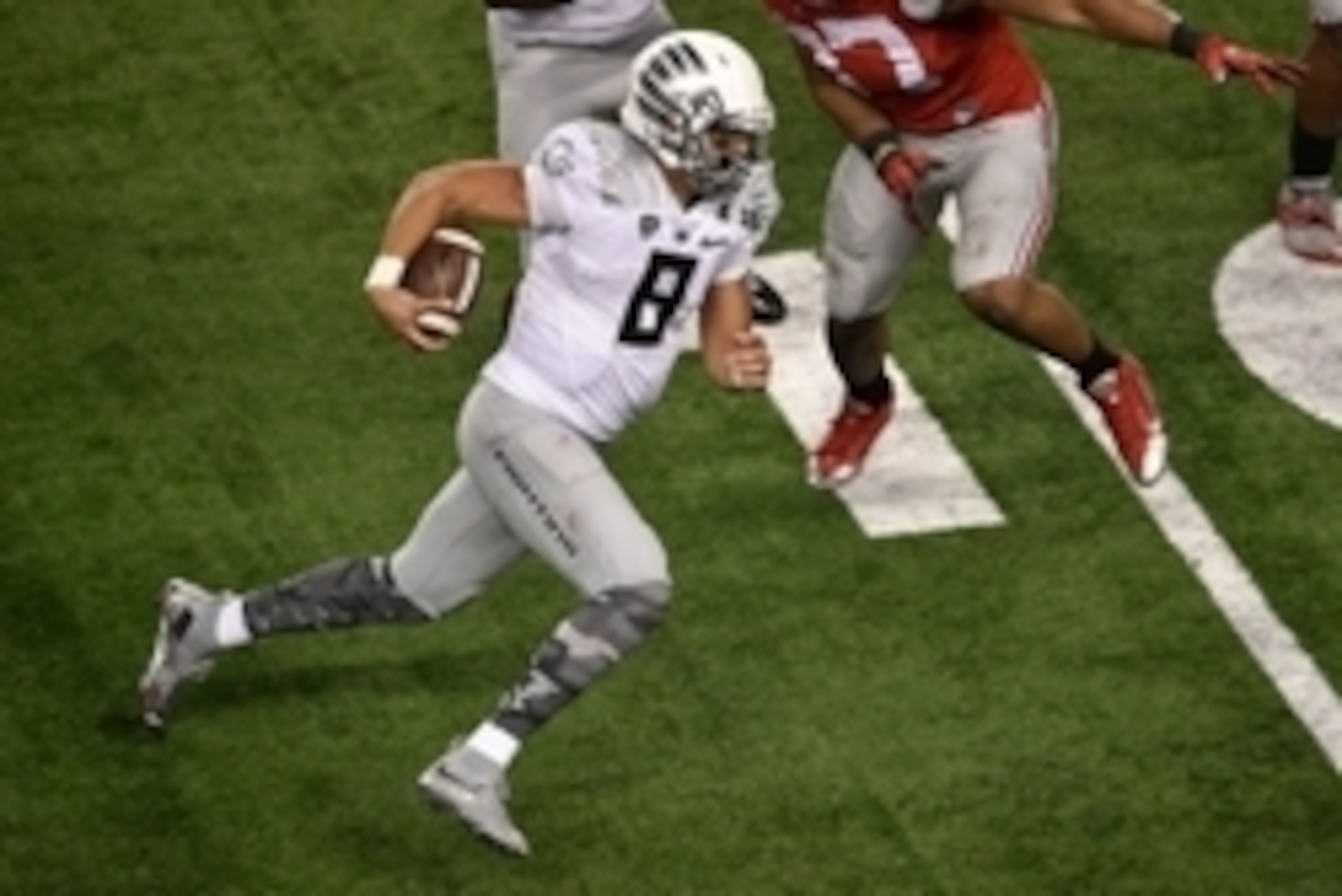 Jan 12, 2015; Arlington, TX, USA; Oregon Ducks quarterback Marcus Mariota (8) runs with the ball against the Ohio State Buckeyes during the game at AT&T Stadium. The Buckeyes defeated the Ducks 42-20. Mandatory Credit: Jerome Miron-USA TODAY Sports