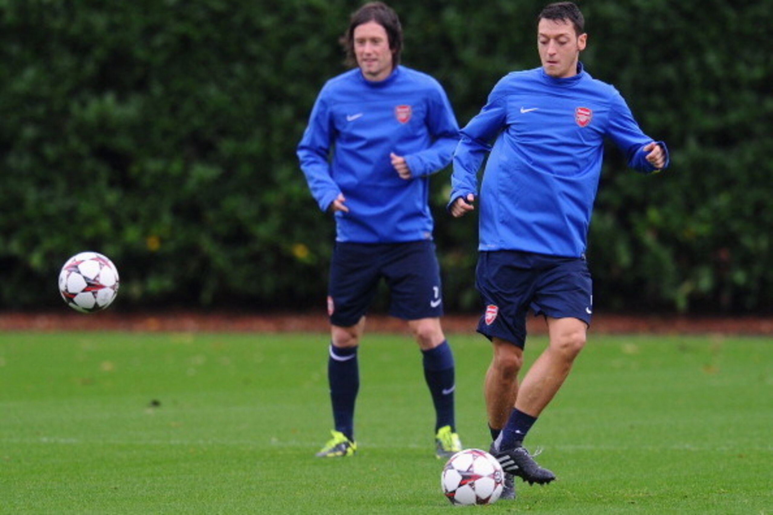 ST ALBANS, ENGLAND - OCTOBER 21:  Mesut Oezil (R) and Tomas Rosicky of Arsenal in action during an Arsenal training session ahead of the UEFA Champions League Group F match against Borussia Dortmund at London Colney on October 21, 2013 in St Albans, Engla