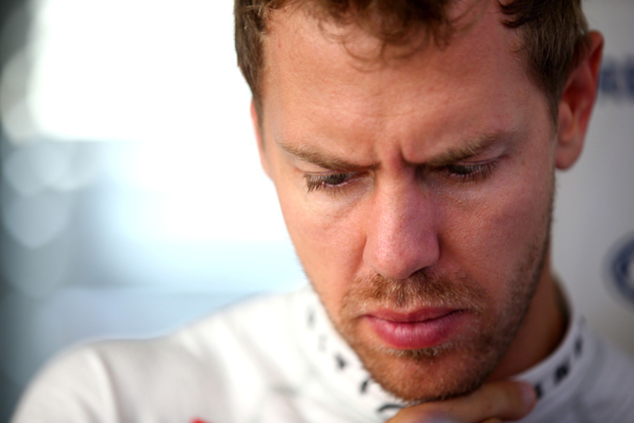 SUZUKA, JAPAN - OCTOBER 03:  Sebastian Vettel of Germany and Infiniti Red Bull Racing looks on in the team garage during practice for the Japanese Formula One Grand Prix at Suzuka Circuit on October 3, 2014 in Suzuka, Japan.  (Photo by Mark Thompson/Getty