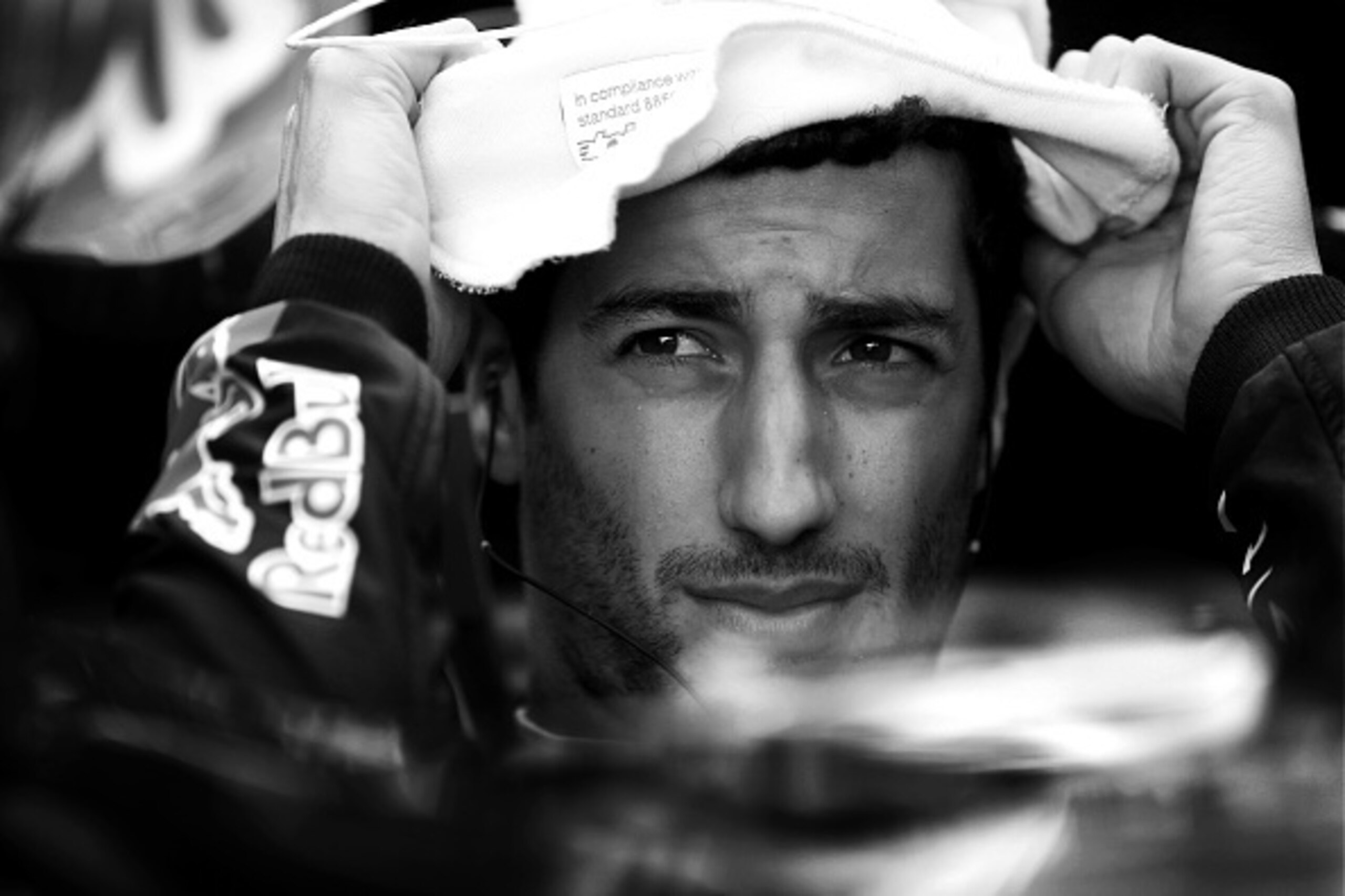SAO PAULO, BRAZIL - NOVEMBER 08:  (EDITORS NOTE: Image has been converted to black and white)   Daniel Ricciardo of Australia and Infiniti Red Bull Racing prepares in the garage during final practice for the Brazilian Formula One Grand Prix at Autodromo J