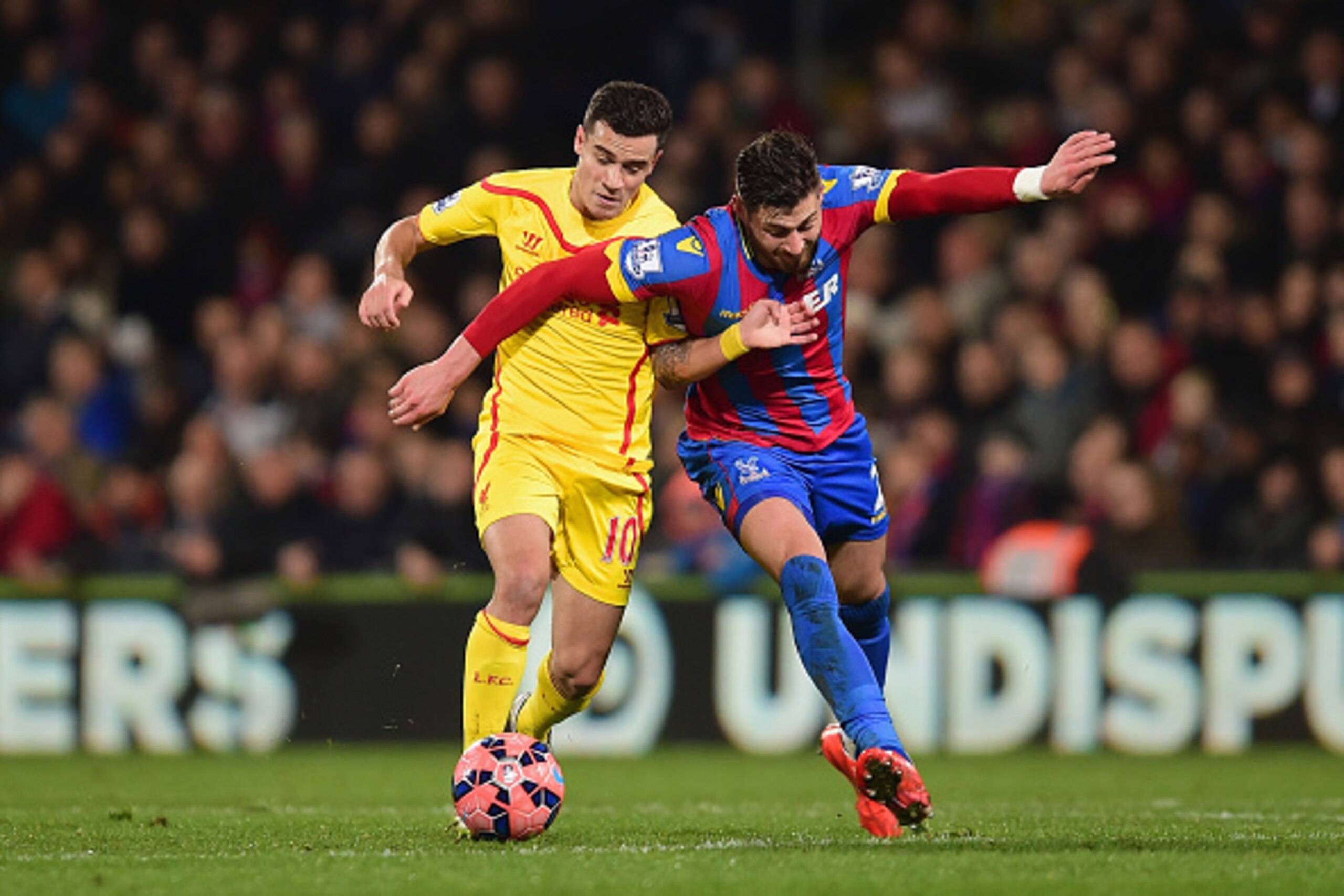 LONDON, ENGLAND - FEBRUARY 14:  Philippe Coutinho of Liverpool and Joel Ward of Crystal Palace battle for the ball during the FA Cup fifth round match between Crystal Palace and Liverpool at Selhurst Park on February 14, 2015 in London, England.  (Photo b