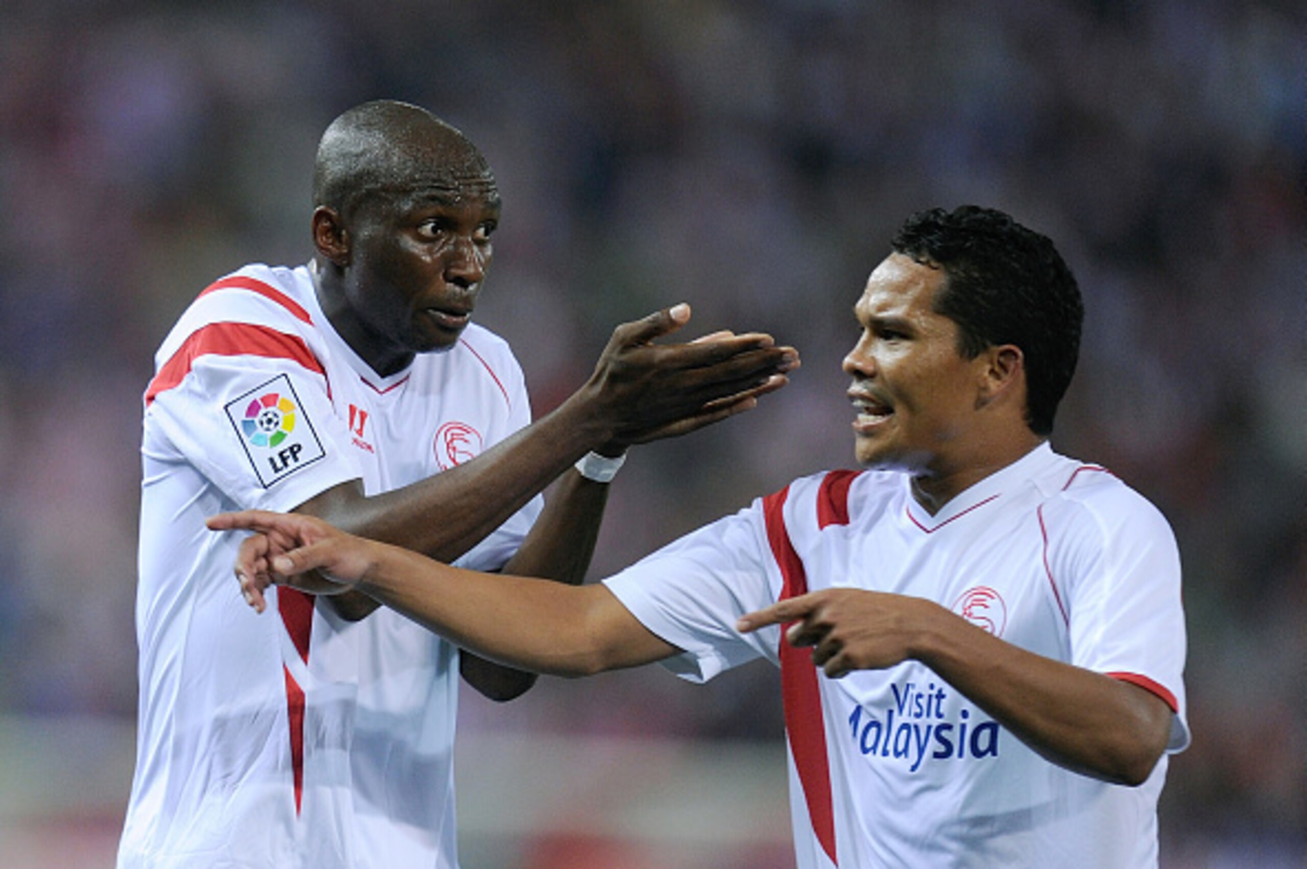 MADRID, SPAIN - SEPTEMBER 27:  Stephane Mbia (L) and Carlos Bacca of Sevilla FC argue during the La Liga match between Club Atletico de Madrid and Sevilla FC at Vicente Calderon Stadium on September 27, 2014 in Madrid, Spain.  (Photo by Denis Doyle/Getty 