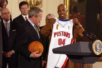 WASHINGTON - JANUARY 31: Chauncey Billups (R) of the Detroit Pistons presents President Bush with a team jersey while visiting the White House January 31, 2005 in Washington, D.C. President Bush hosted the Pistons to honor their 2004 NBA Championship. NOT