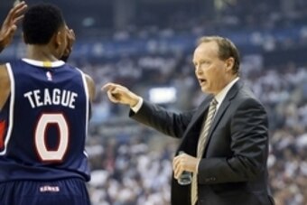 Oct 29, 2014; Toronto, Ontario, CAN; Atlanta Hawks head coach Mike Budenholzer talks to guard Jeff Teague (0) during a break in the action against Toronto Raptors at the Air Canada Centre. Toronto defeated Atlanta 109-102. Mandatory Credit: John E. Sokolo