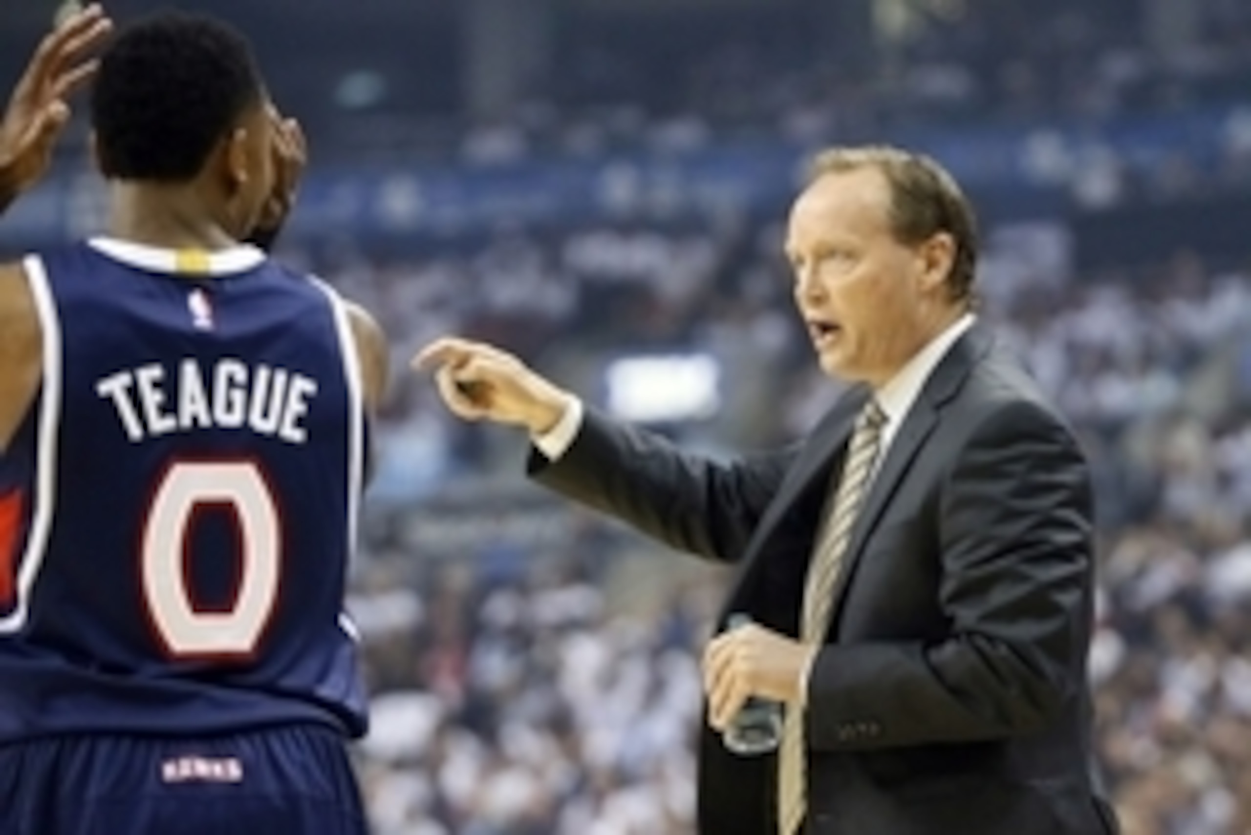 Oct 29, 2014; Toronto, Ontario, CAN; Atlanta Hawks head coach Mike Budenholzer talks to guard Jeff Teague (0) during a break in the action against Toronto Raptors at the Air Canada Centre. Toronto defeated Atlanta 109-102. Mandatory Credit: John E. Sokolo