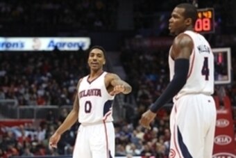 Feb 4, 2015; Atlanta, GA, USA; Atlanta Hawks guard Jeff Teague (0) reacts to a play by forward Paul Millsap (4) in the fourth quarter of their game against the Washington Wizards at Philips Arena. Hawks won 105-96. Mandatory Credit: Jason Getz-USA TODAY S