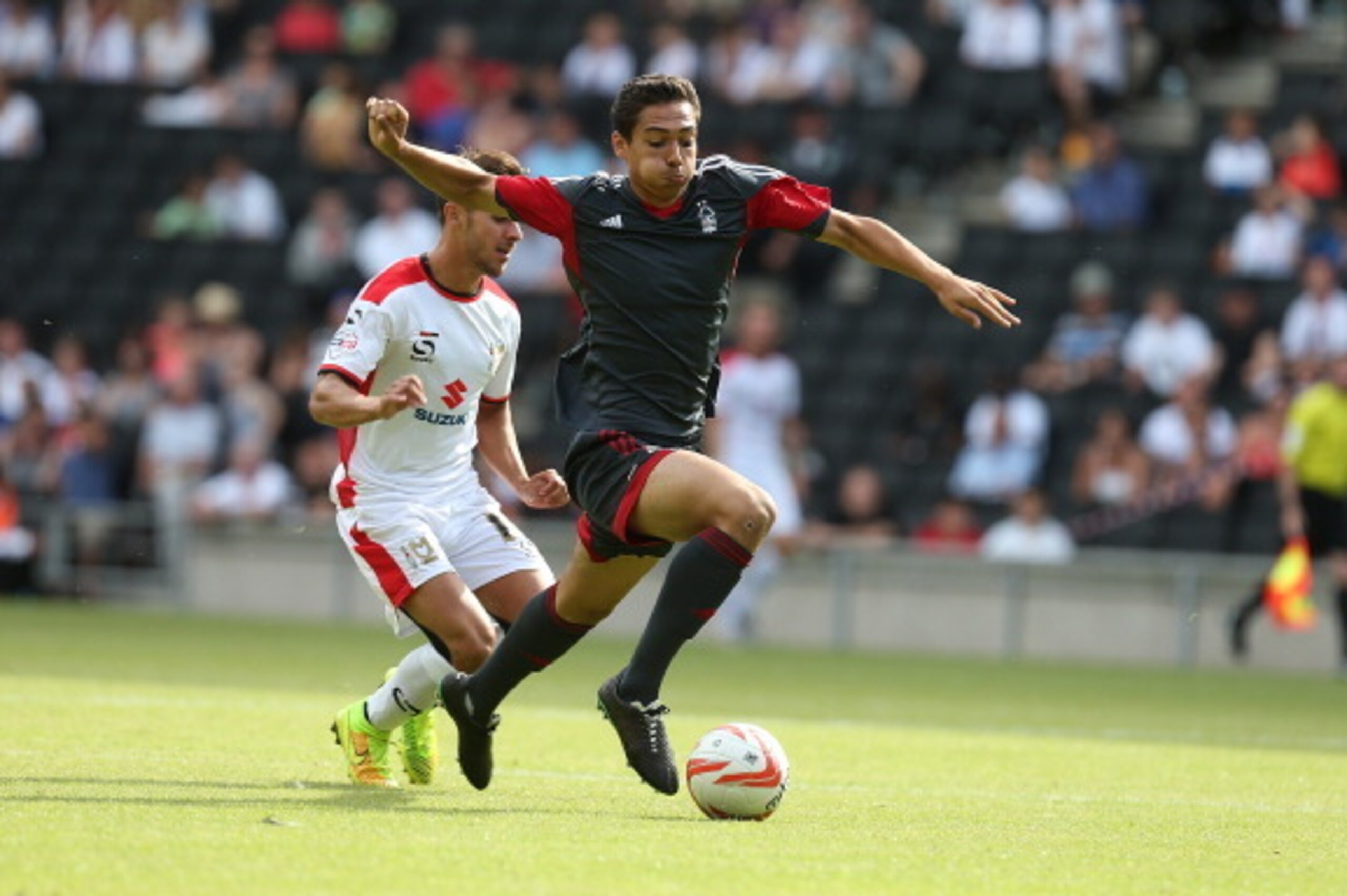 MILTON KEYNES, ENGLAND - JULY 27:  Tyler Walker of Nottingham Forest attempts to move forward with the ball away from George Baldock of MK Dons during the Pre-Season Friendly between MK Dons and Nottingham Forest at Stadium mk on July 27, 2014 in Milton K