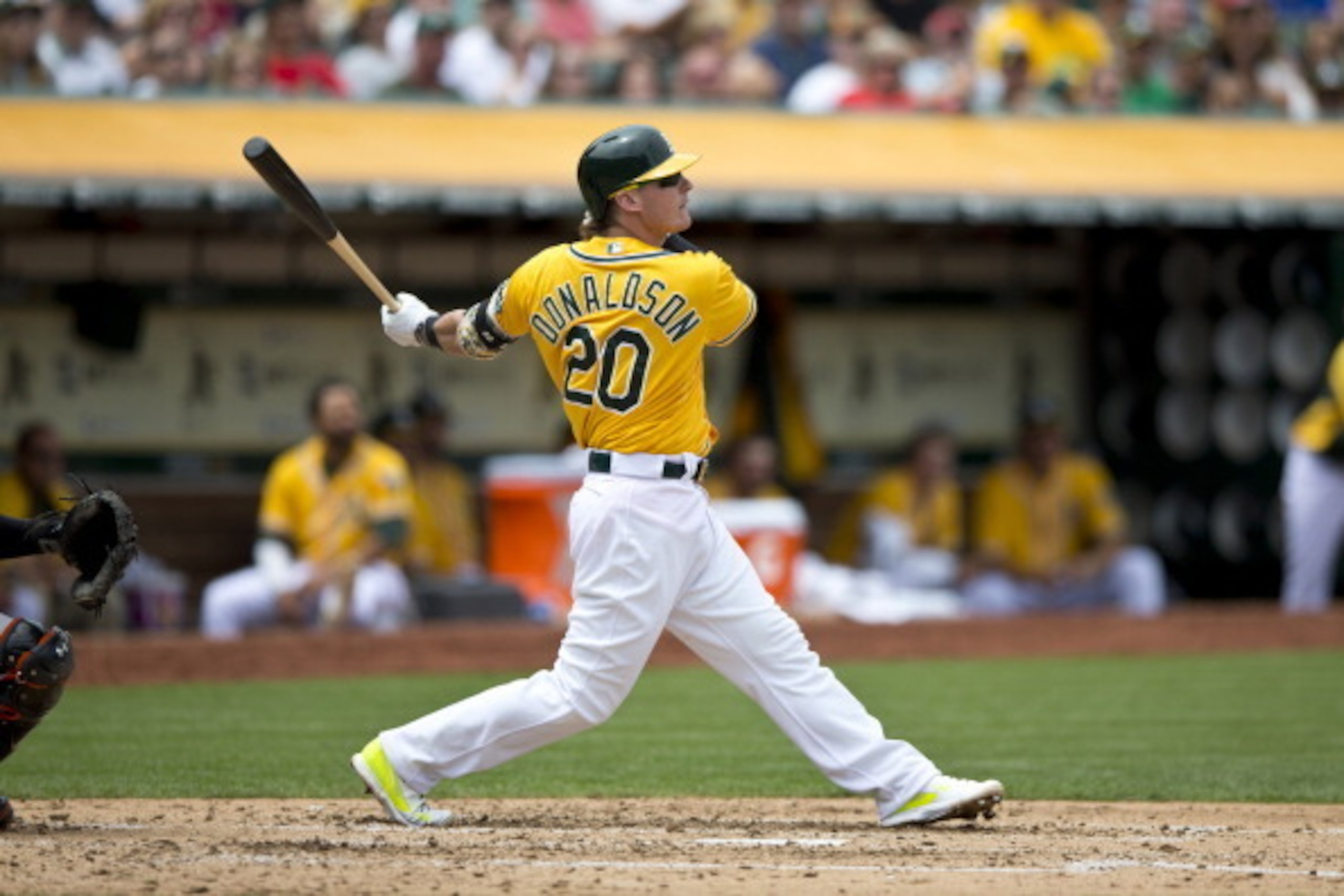 OAKLAND, CA - JULY 20:  Josh Donaldson #20 of the Oakland Athletics hits a sacrifice fly ball for an RBI against the Baltimore Orioles during the third inning at O.co Coliseum on July 20, 2014 in Oakland, California. The Oakland Athletics defeated the Bal